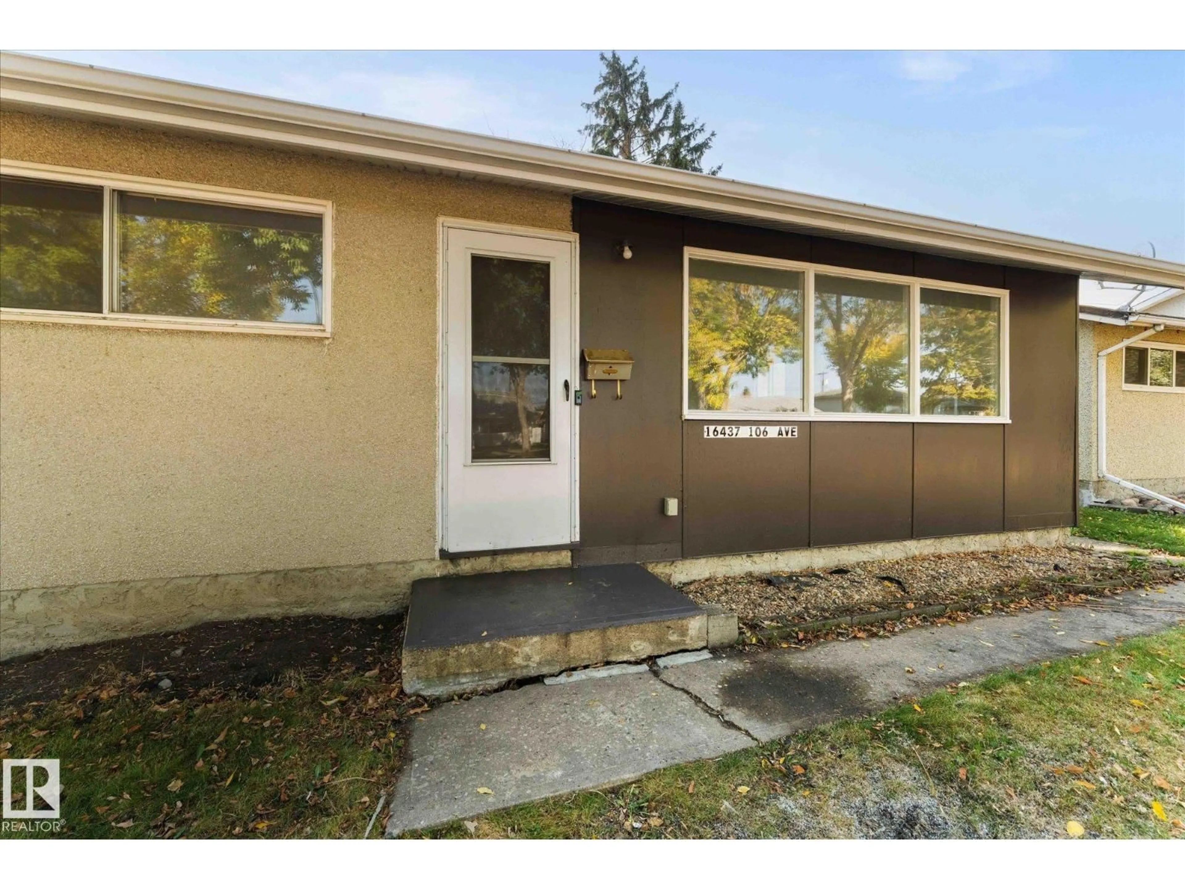 Home with vinyl exterior material, street for 16437 106 AV, Edmonton Alberta T5P0X1