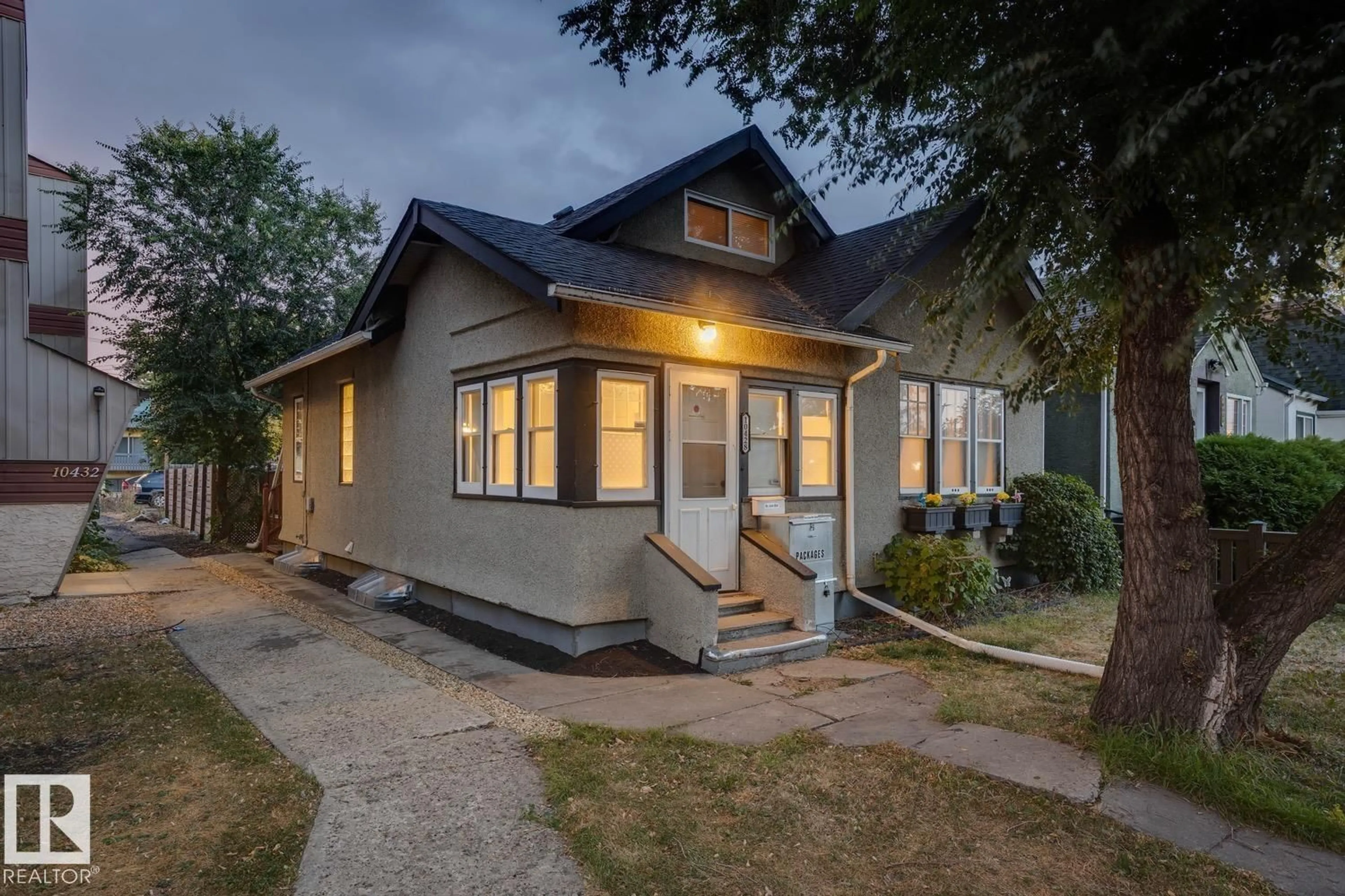 Home with vinyl exterior material, street for 10428 76 AV, Edmonton Alberta T6E1L1