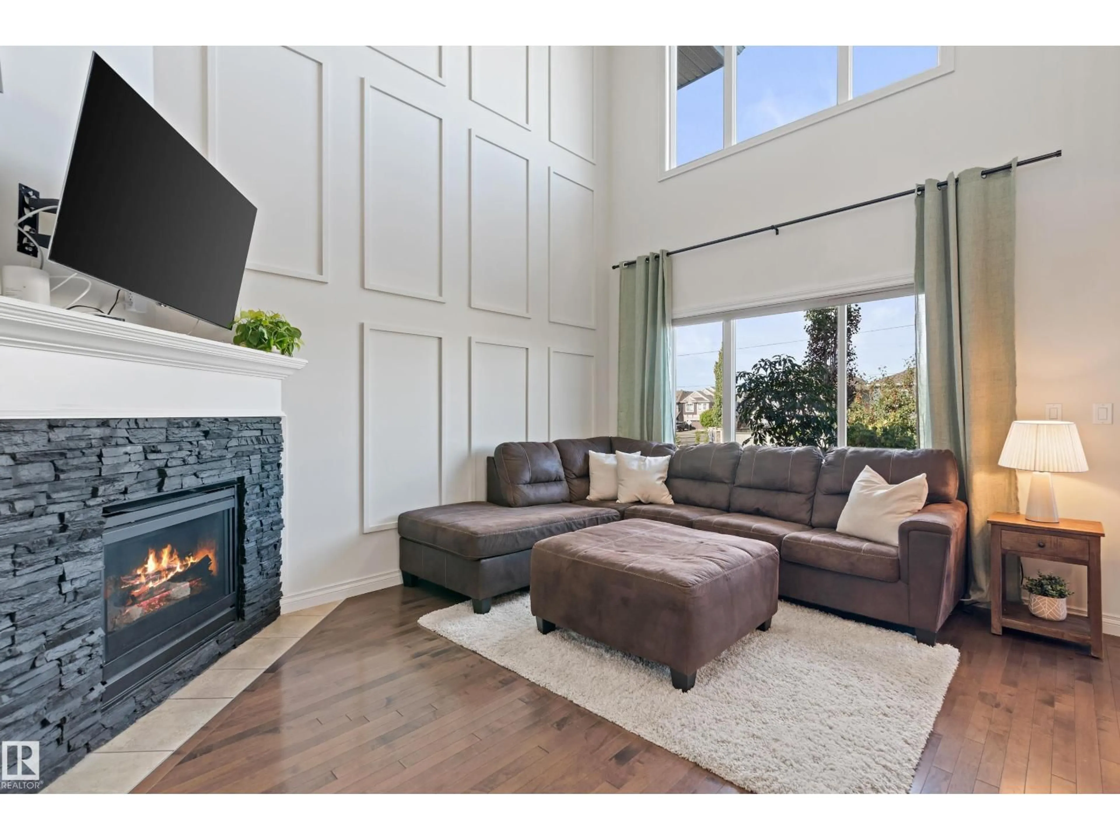 Living room with furniture, wood/laminate floor for SW - 17720 10 AV, Edmonton Alberta T6W2A1