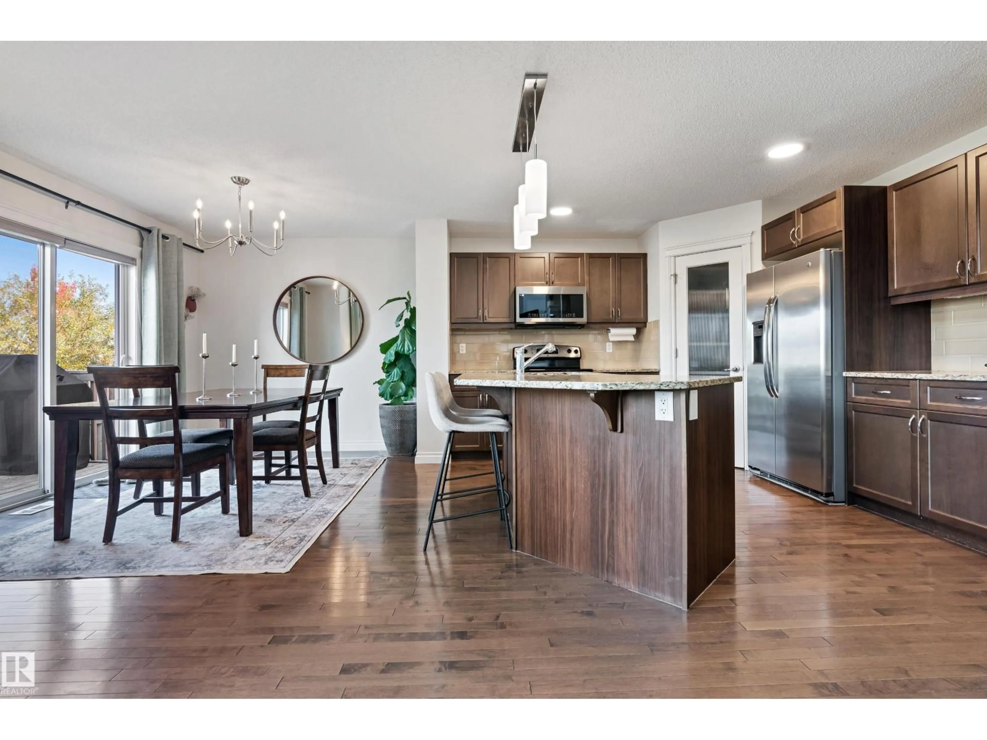 Open concept kitchen, wood/laminate floor for SW - 17720 10 AV, Edmonton Alberta T6W2A1