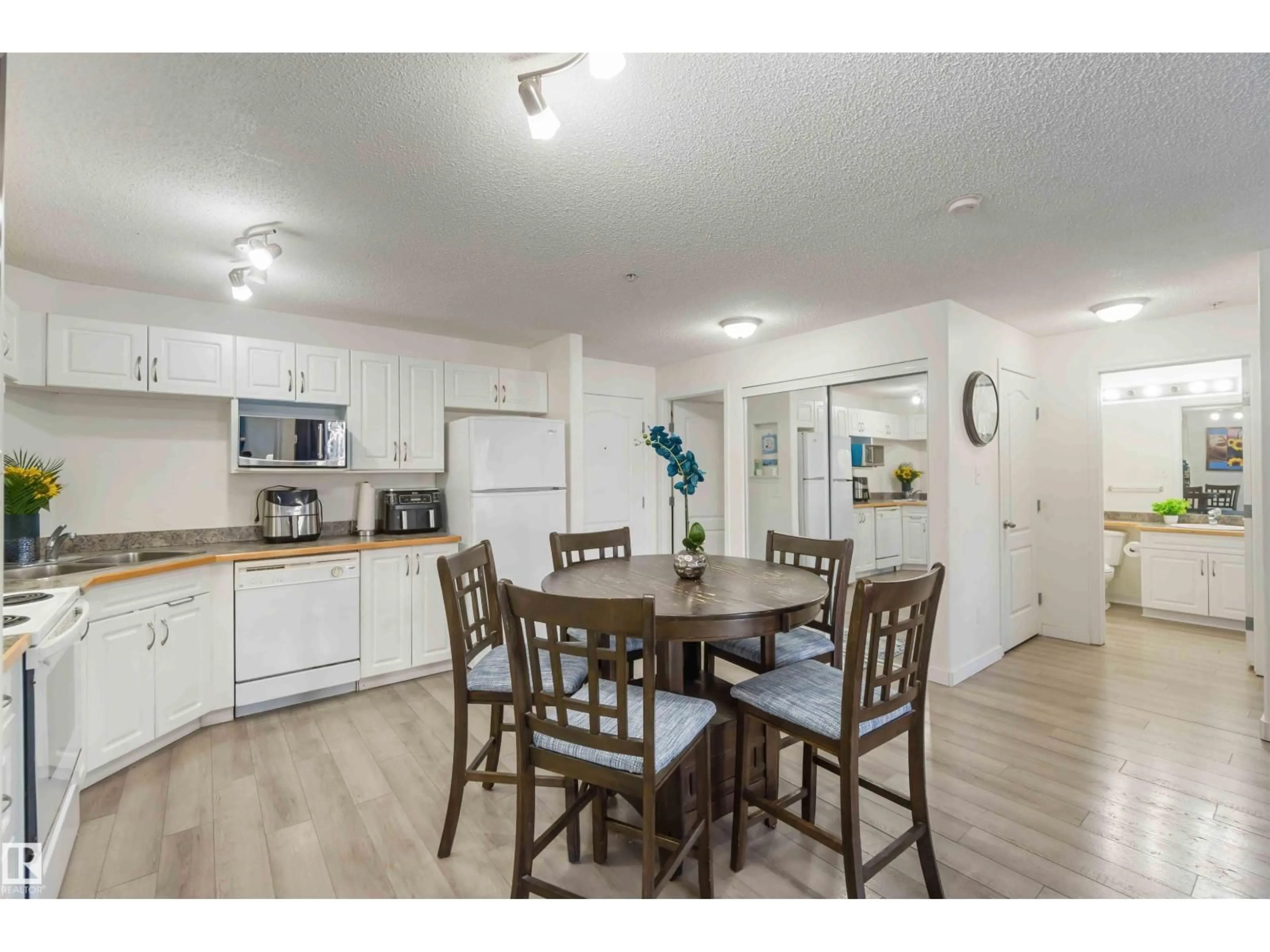 Open concept kitchen, wood/laminate floor for #324 - 5350 199 ST, Edmonton Alberta T6M0A4