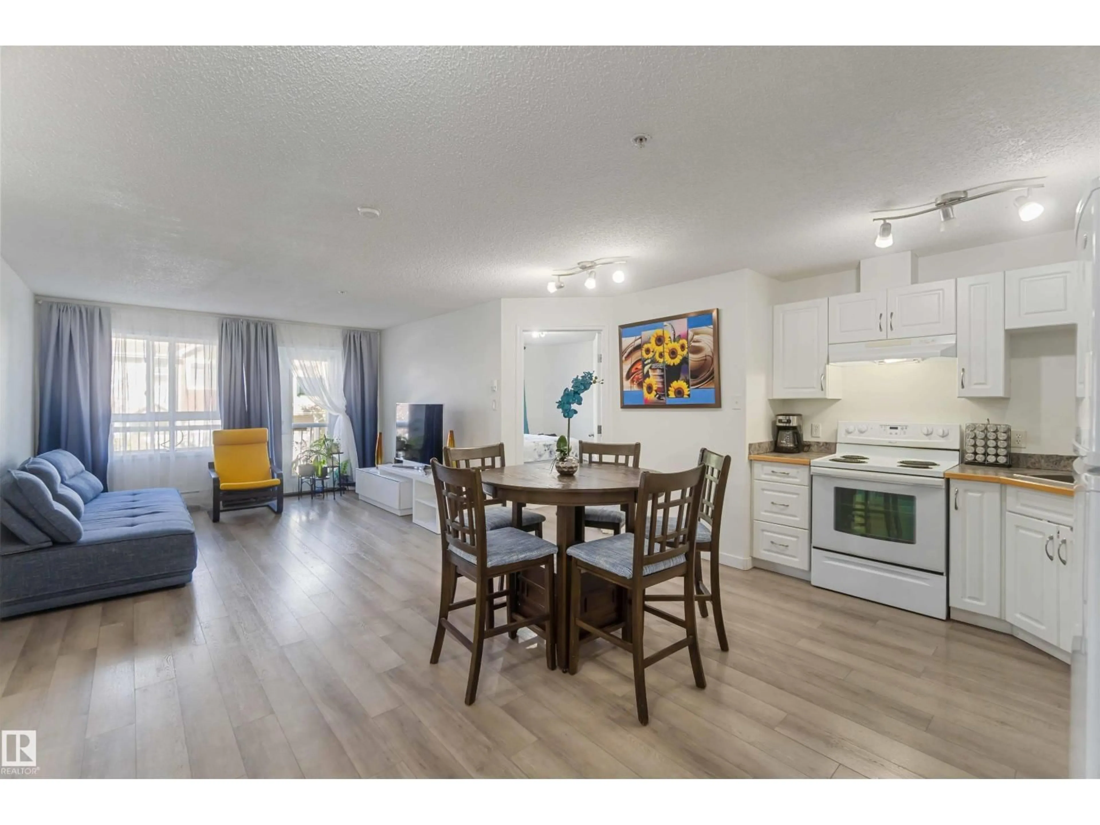 Open concept kitchen, wood/laminate floor for #324 - 5350 199 ST, Edmonton Alberta T6M0A4