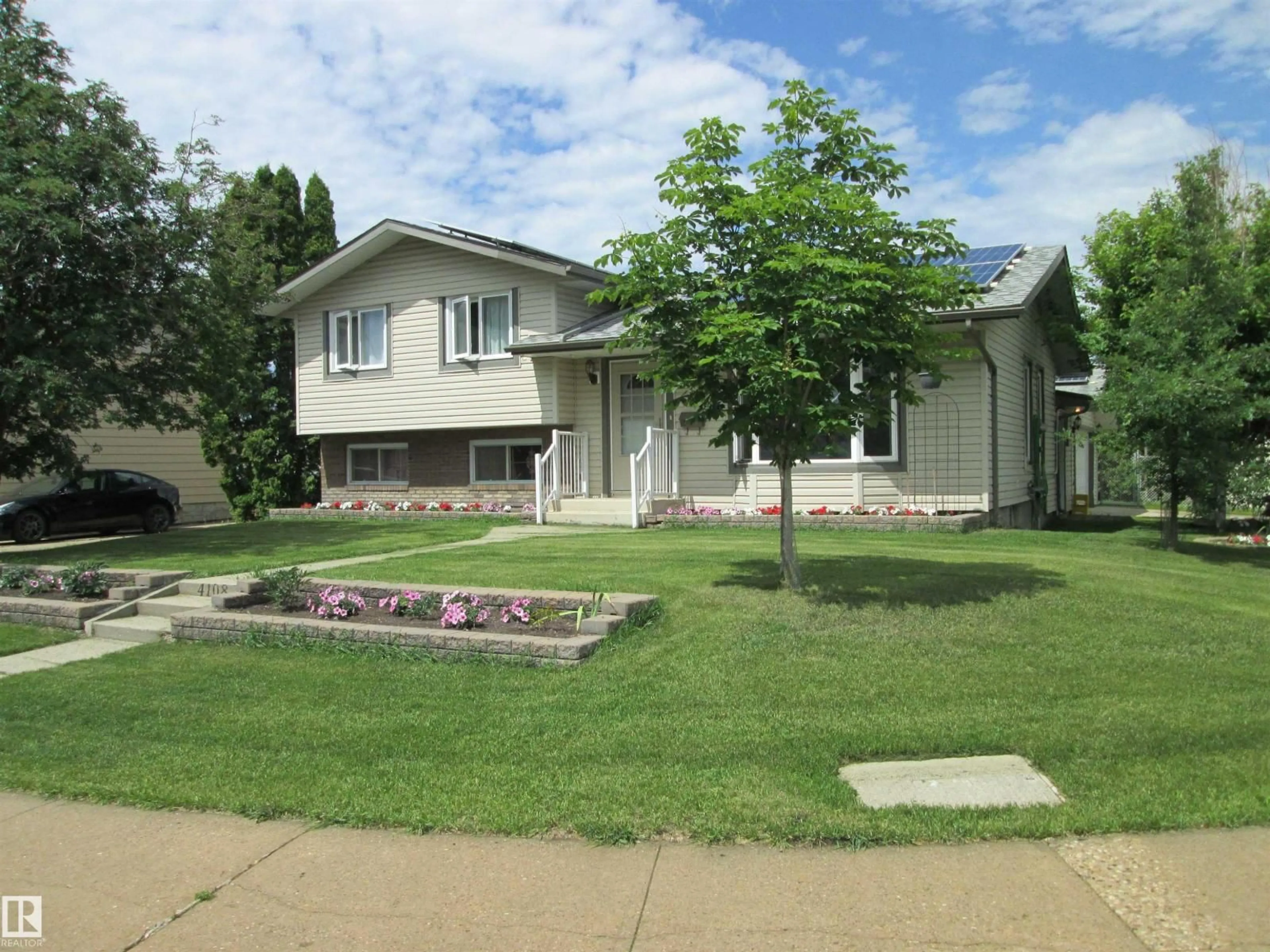 Home with vinyl exterior material, street for 4108 135 AV, Edmonton Alberta T5A2N7