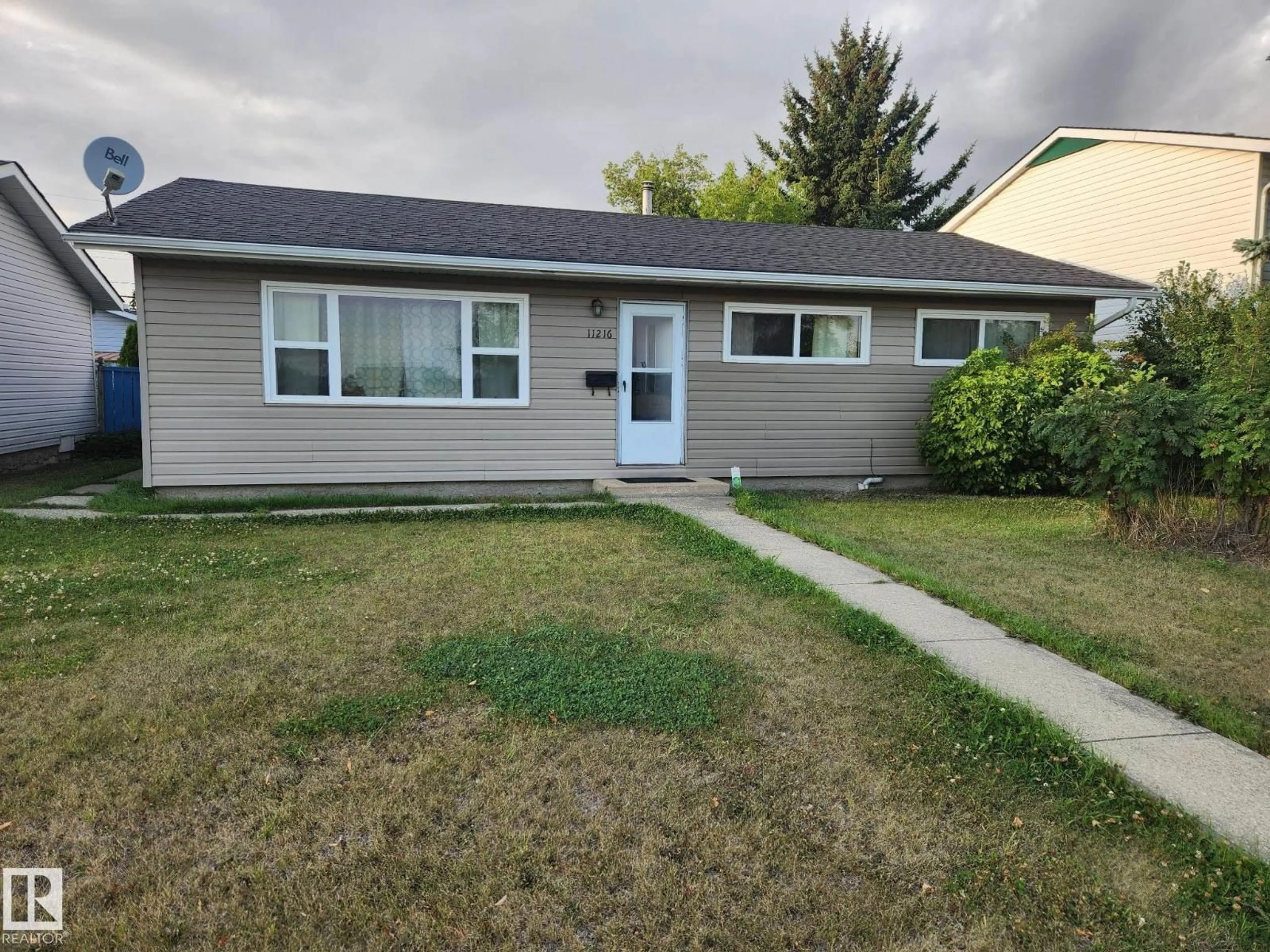 Home with vinyl exterior material, street for 11216 134 AV, Edmonton Alberta T5E1K5