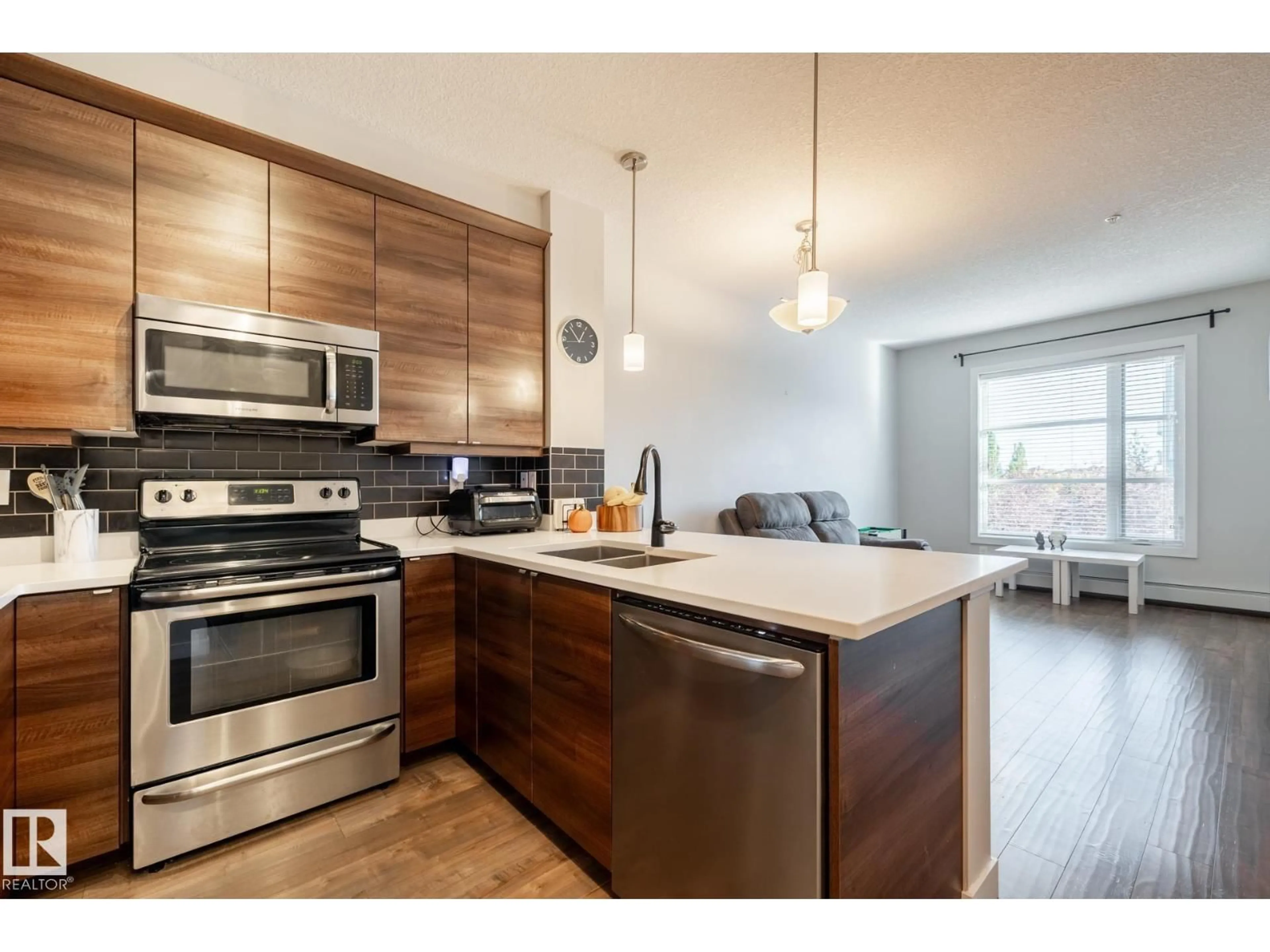 Open concept kitchen, wood/laminate floor for #202 - 2590 ANDERSON WY, Edmonton Alberta T6W0R2