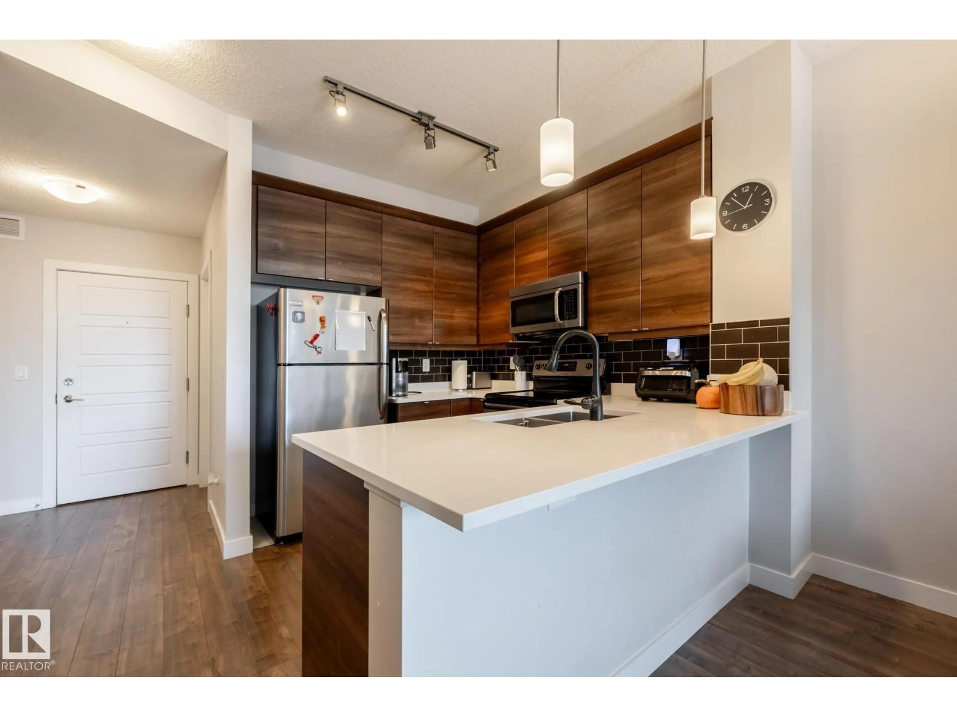 Open concept kitchen, wood/laminate floor for #202 - 2590 ANDERSON WY, Edmonton Alberta T6W0R2
