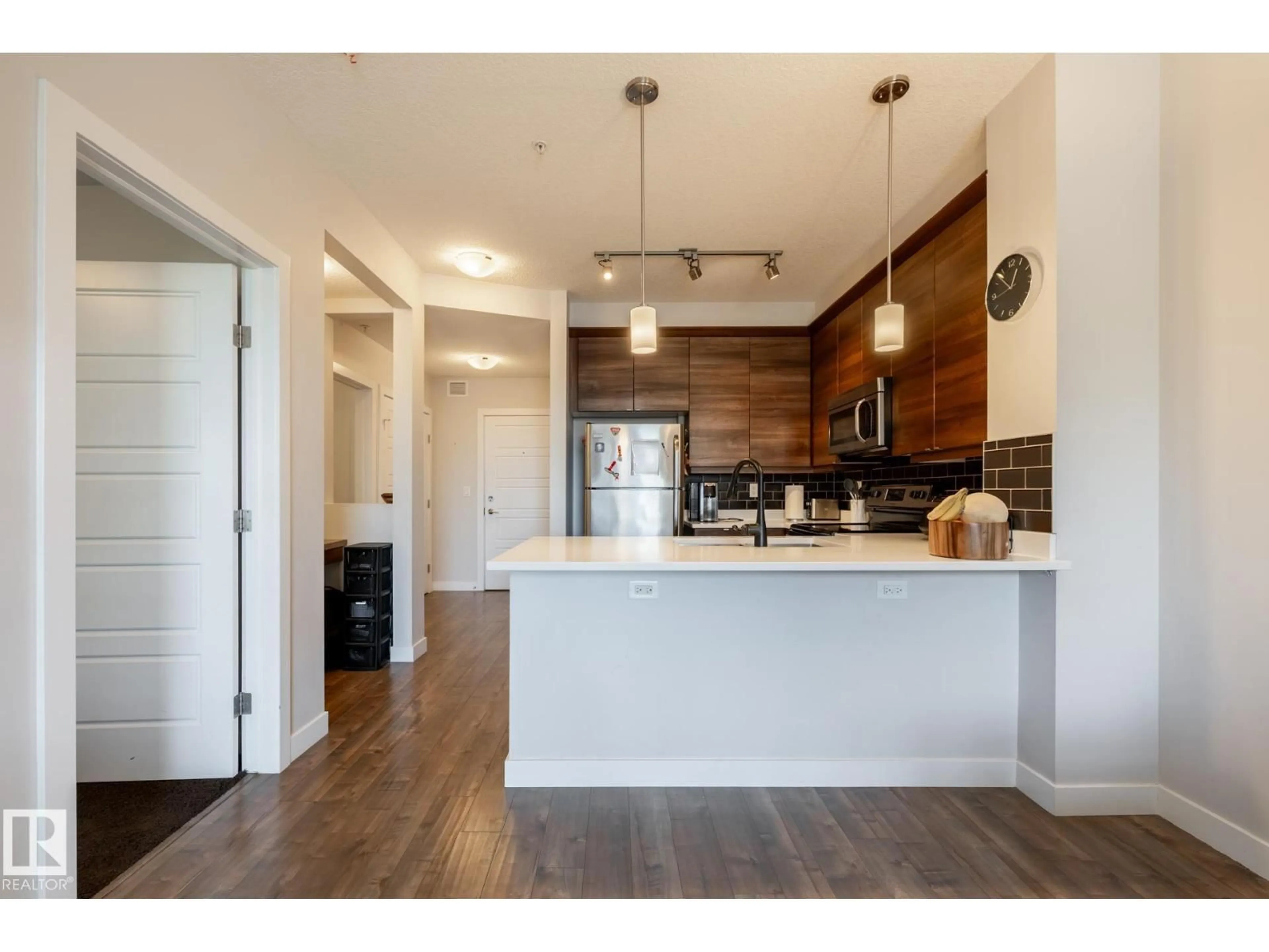 Open concept kitchen, wood/laminate floor for #202 - 2590 ANDERSON WY, Edmonton Alberta T6W0R2