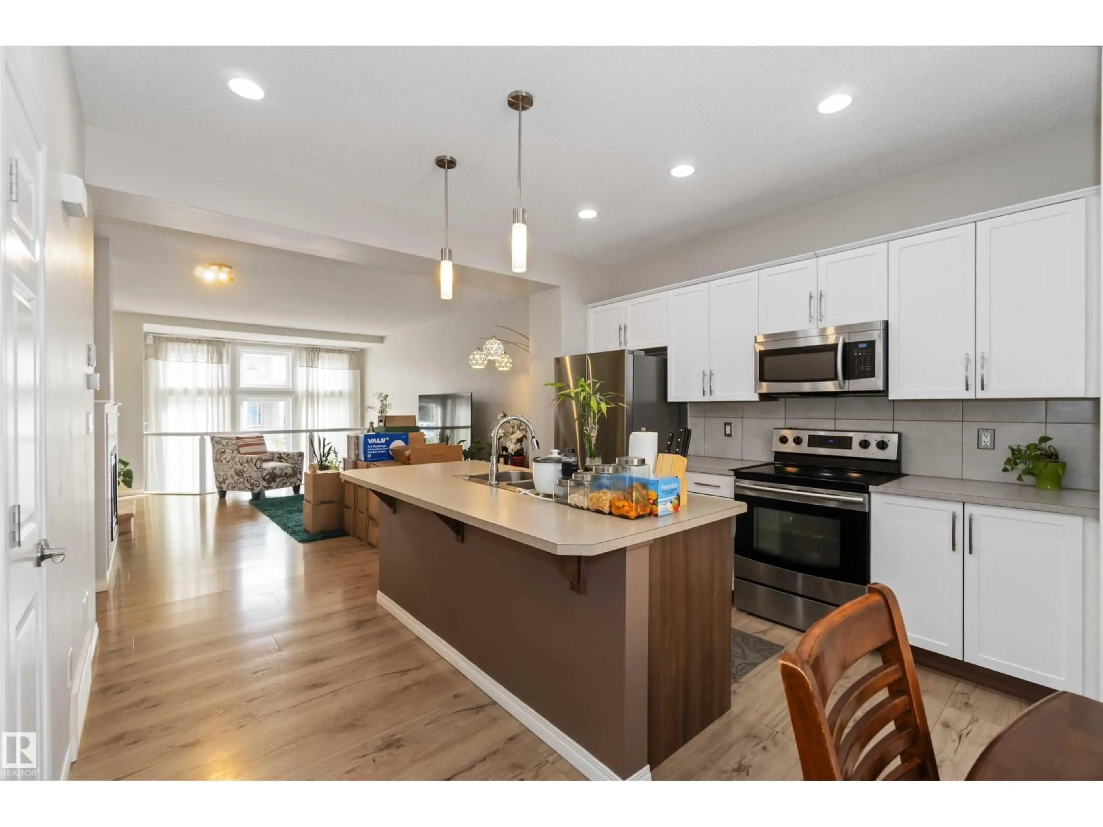 Open concept kitchen, wood/laminate floor for NW - 9932 221 ST, Edmonton Alberta T5T4M7