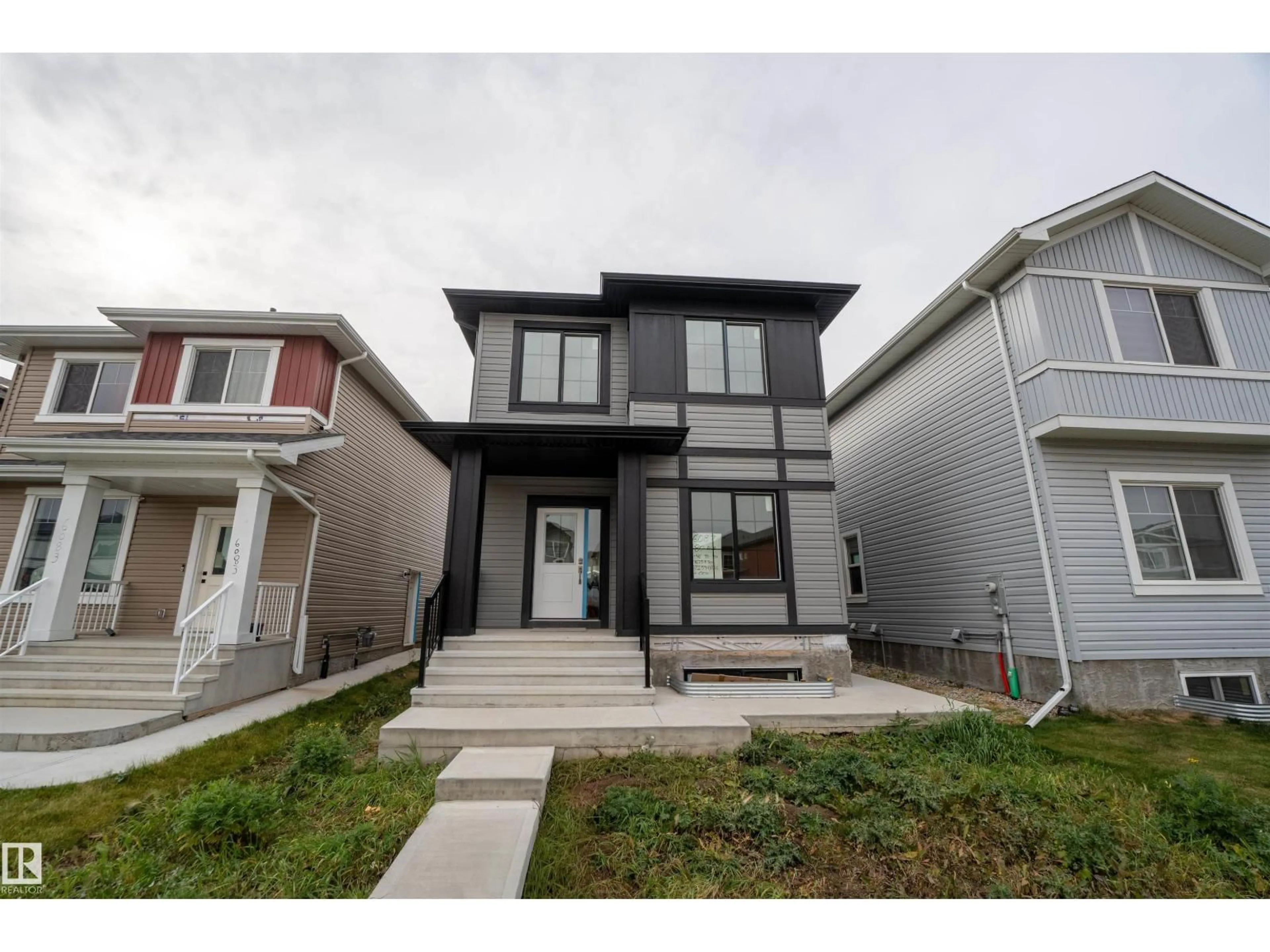 Home with vinyl exterior material, street for NW - 6087 180 AV, Edmonton Alberta T5Y3X1