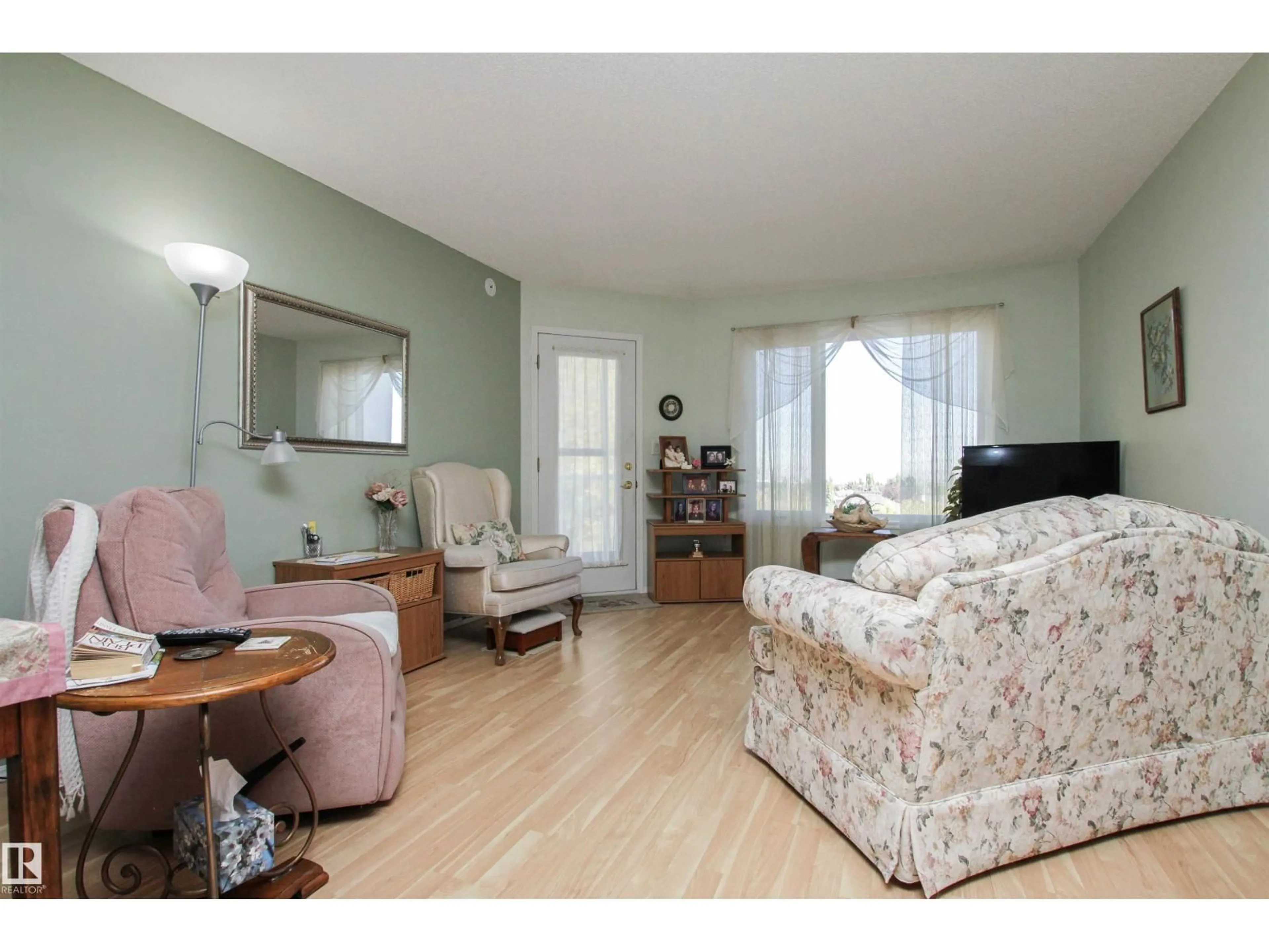 Living room with furniture, wood/laminate floor for 69 - 404 CRYSTAL LN, Sherwood Park Alberta T8H2E9