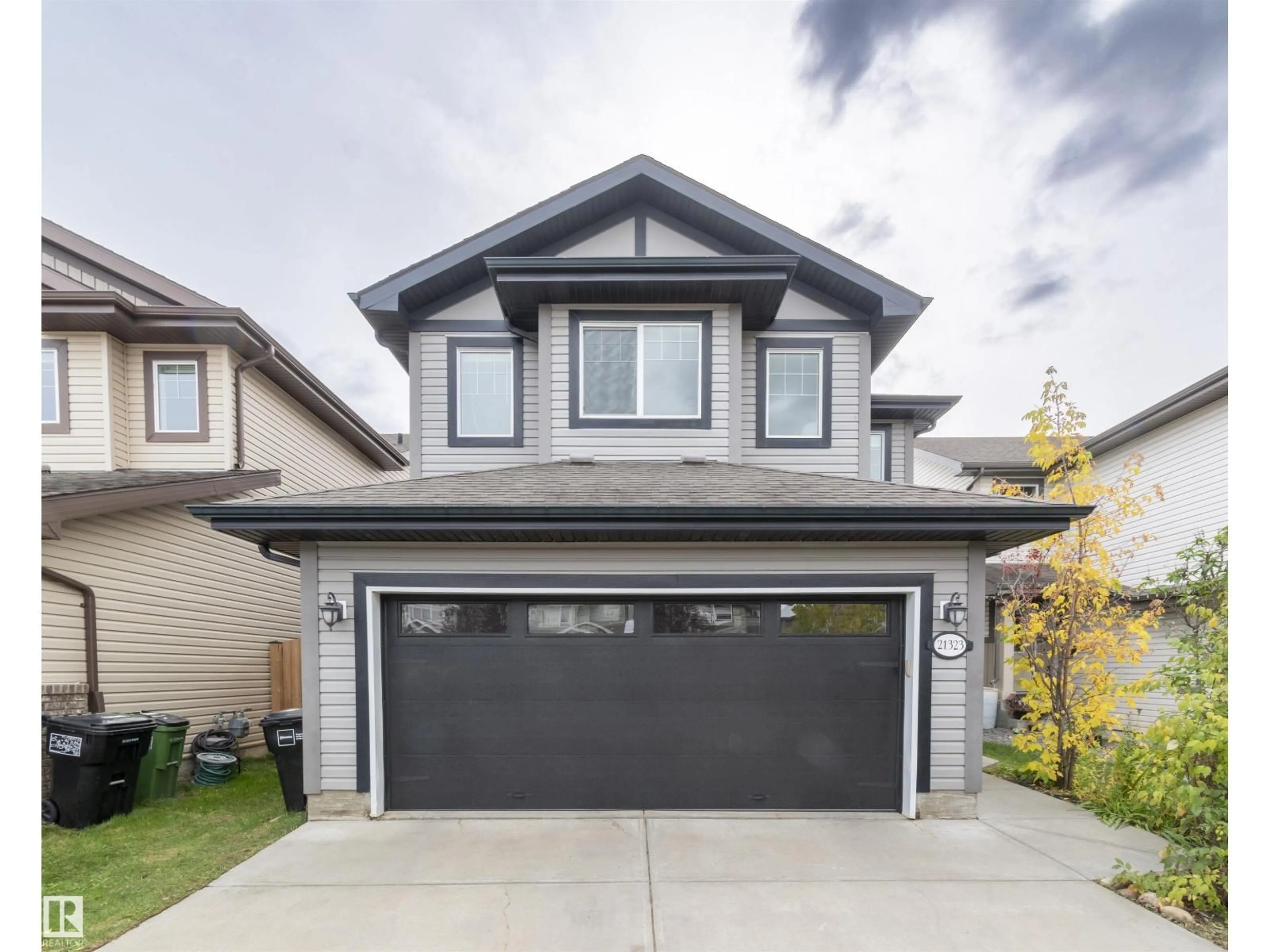 Home with vinyl exterior material, street for NW - 21323 58 AV, Edmonton Alberta T6M0H4