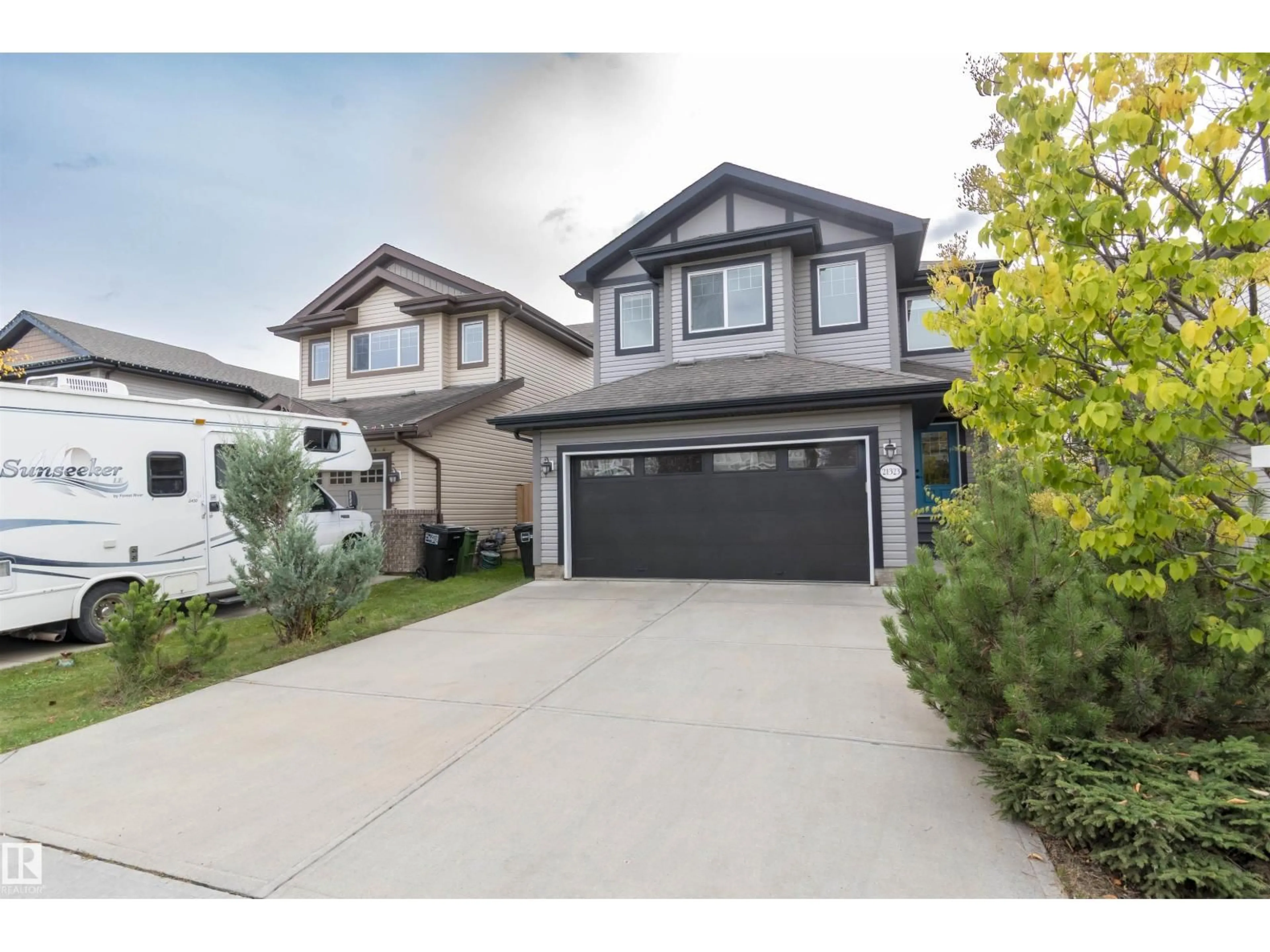 Home with vinyl exterior material, street for NW - 21323 58 AV, Edmonton Alberta T6M0H4