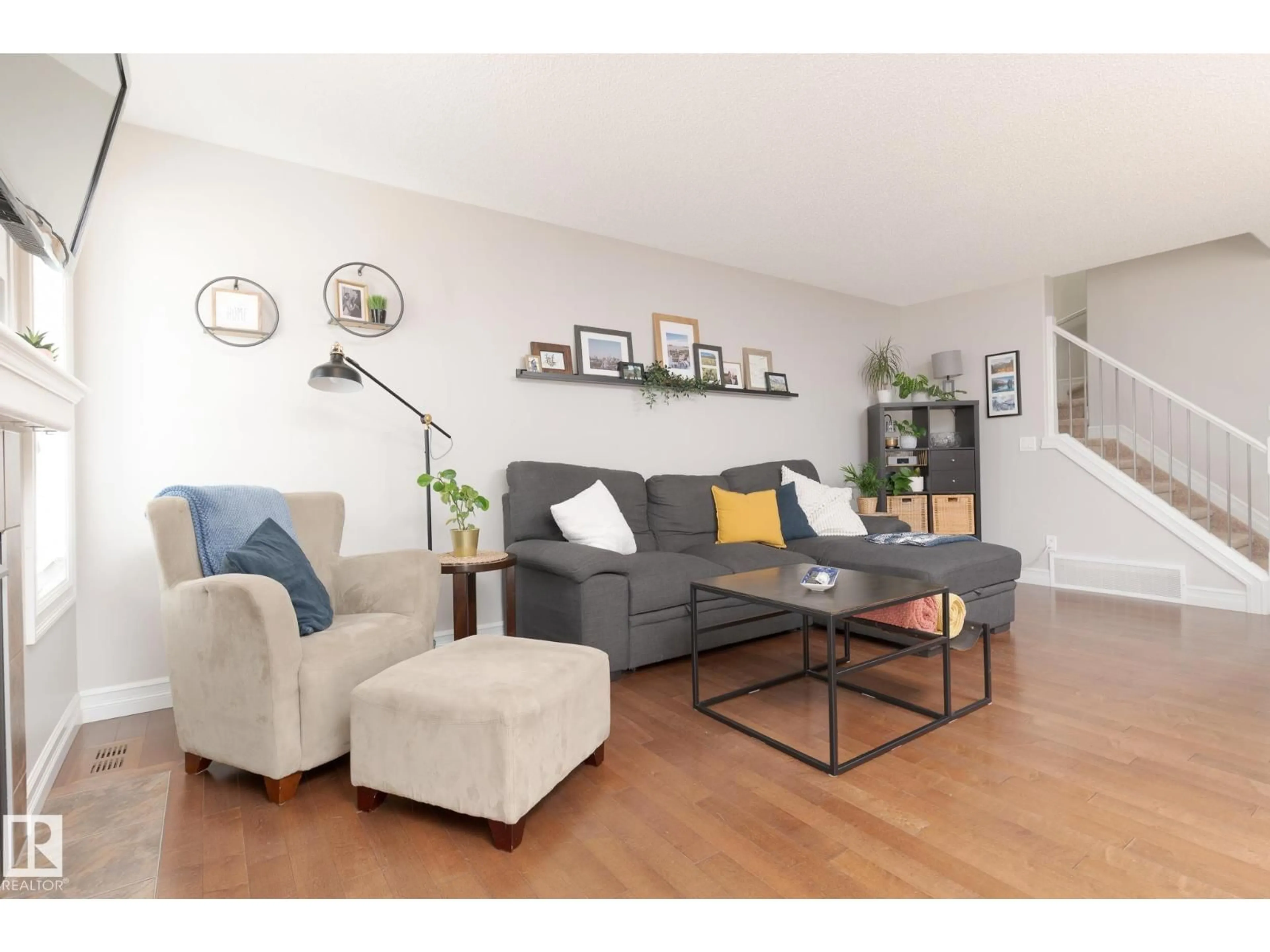 Living room with furniture, wood/laminate floor for 3013 16A AV, Edmonton Alberta T6T0P8