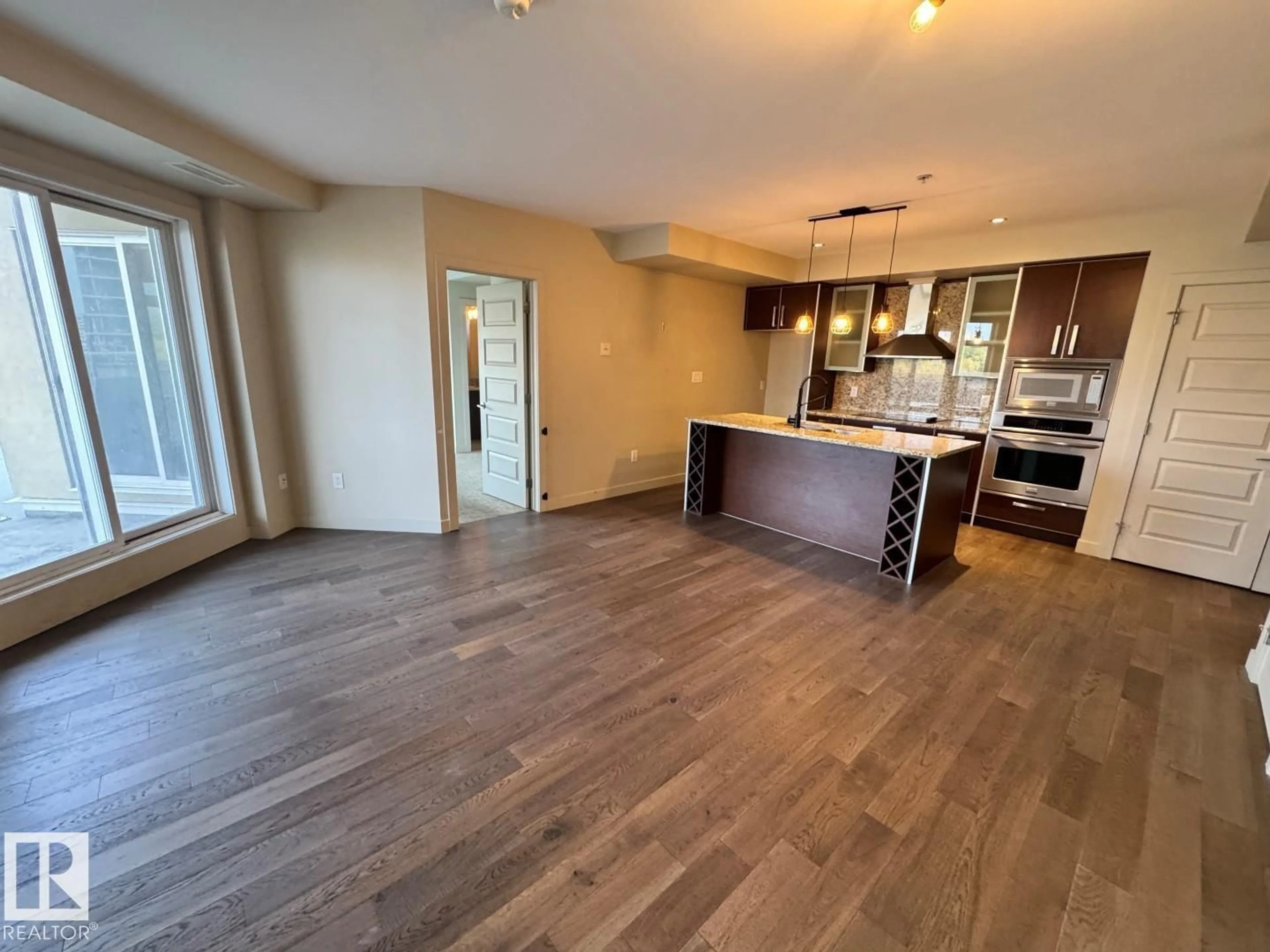 Open concept kitchen, wood/laminate floor for #307 - 10388 105 ST, Edmonton Alberta T5J0C2