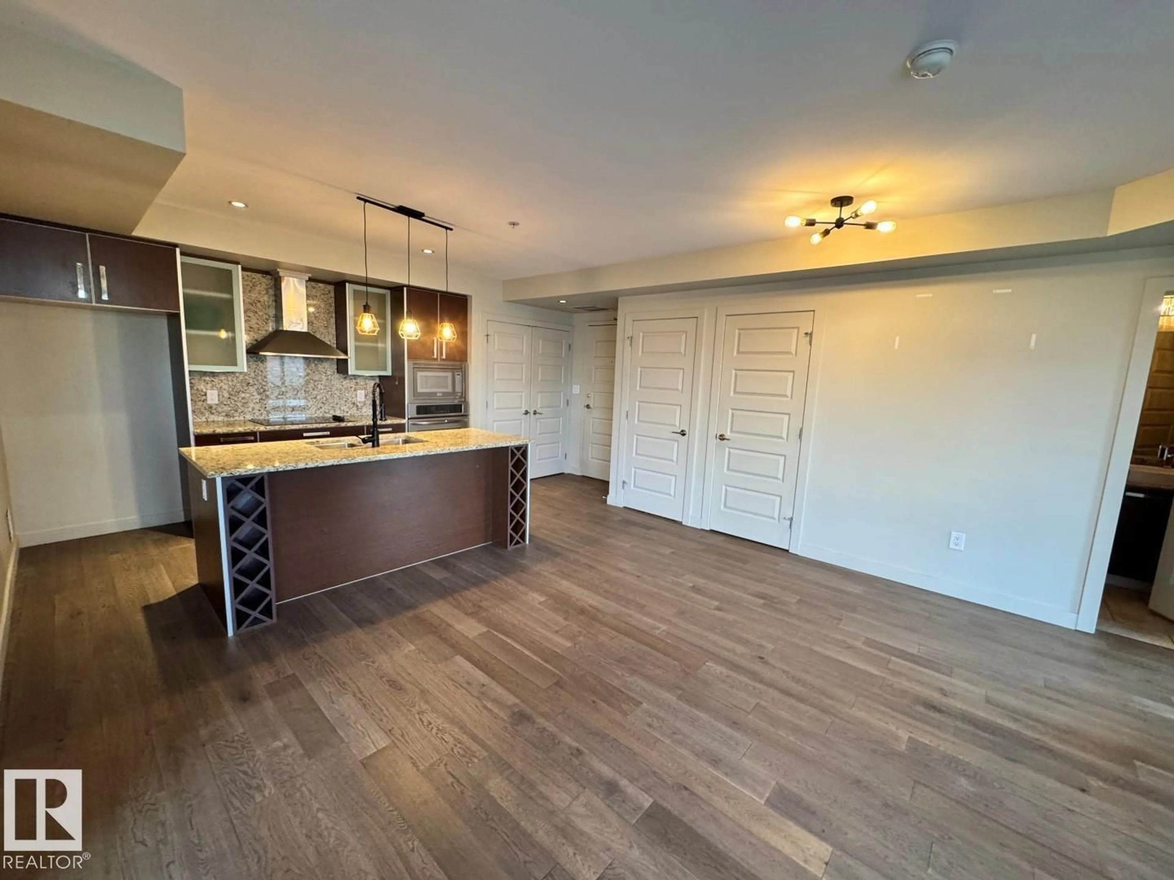 Open concept kitchen, wood/laminate floor for #307 - 10388 105 ST, Edmonton Alberta T5J0C2
