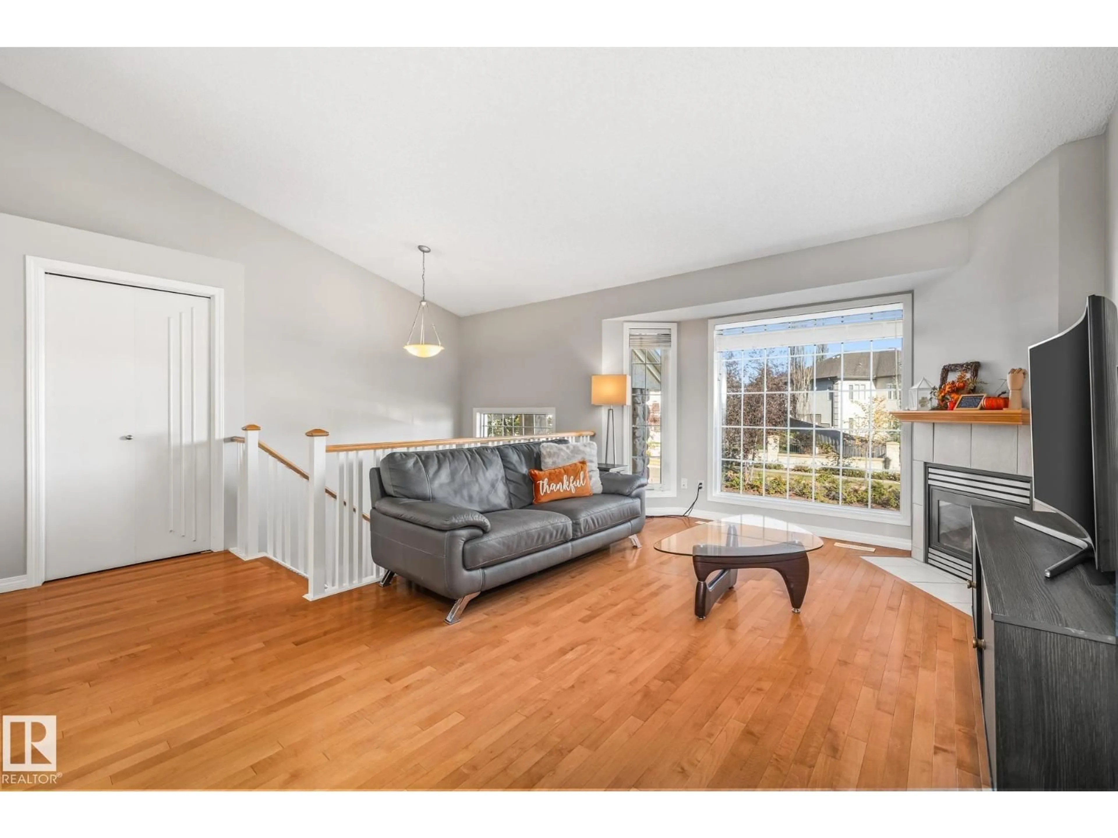 Living room with furniture, wood/laminate floor for #3 - 303 LEGER WY, Edmonton Alberta T6X1X5