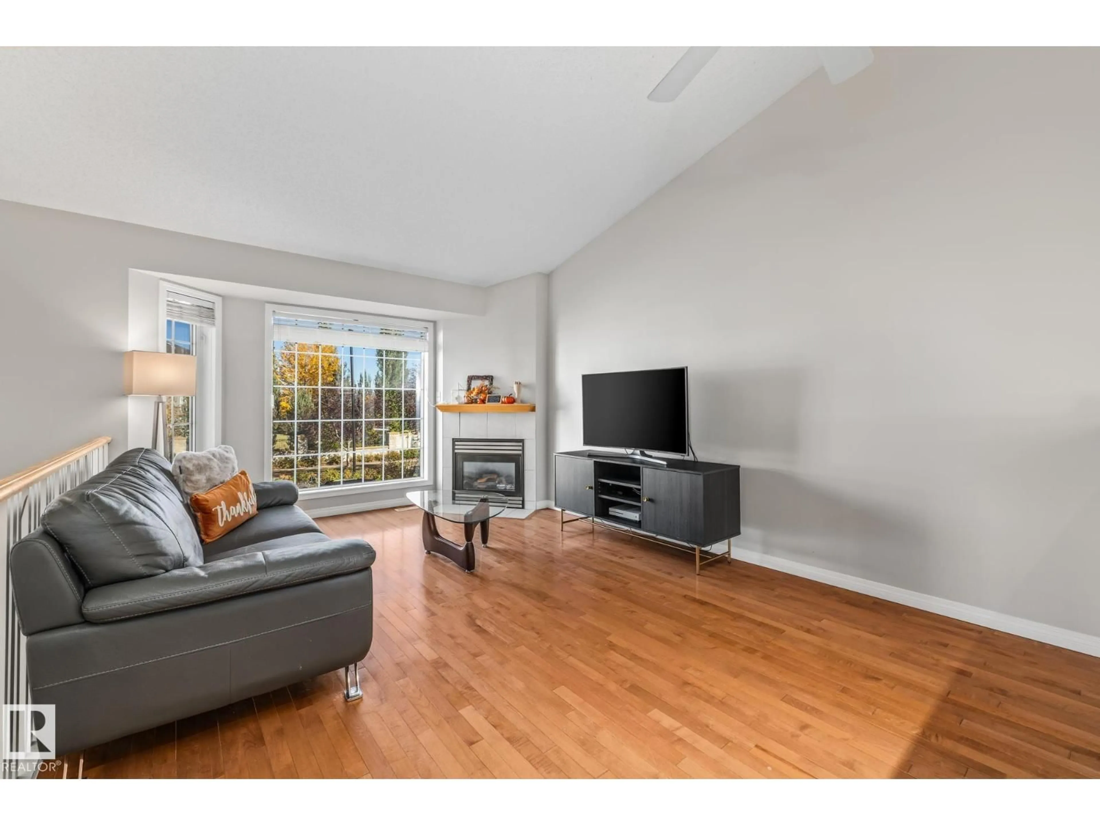 Living room with furniture, wood/laminate floor for #3 - 303 LEGER WY, Edmonton Alberta T6X1X5