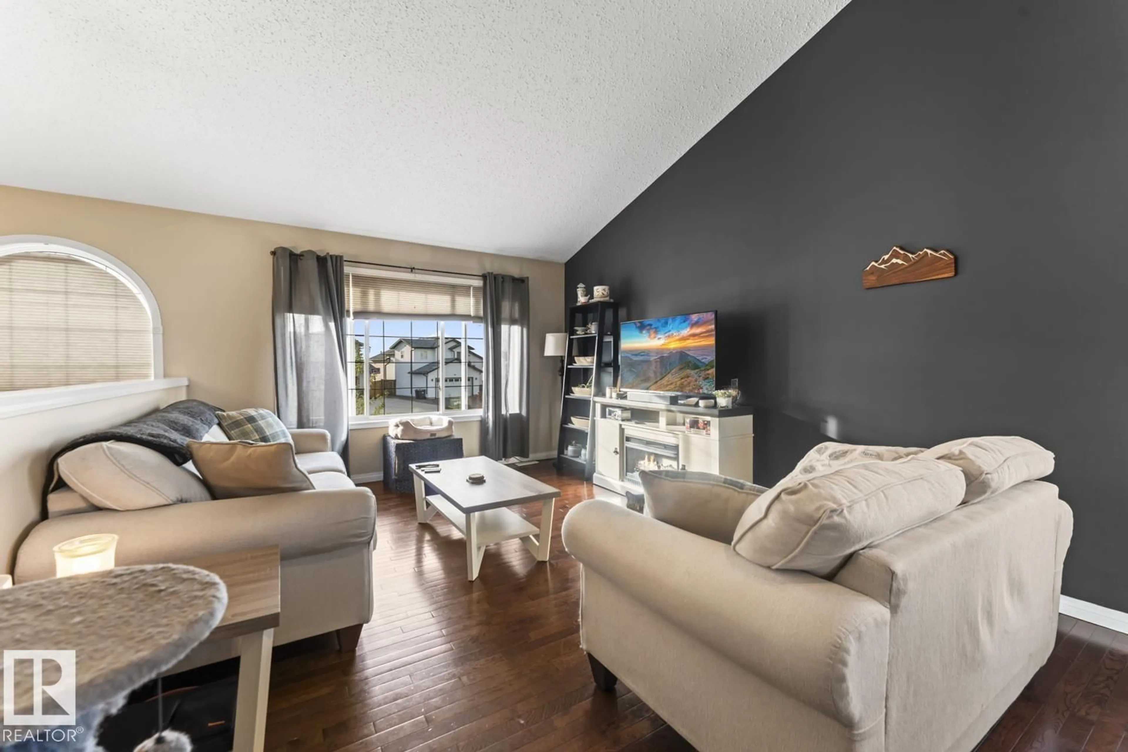 Living room with furniture, wood/laminate floor for 708 GROUSE CL, Cold Lake Alberta T9M0A5