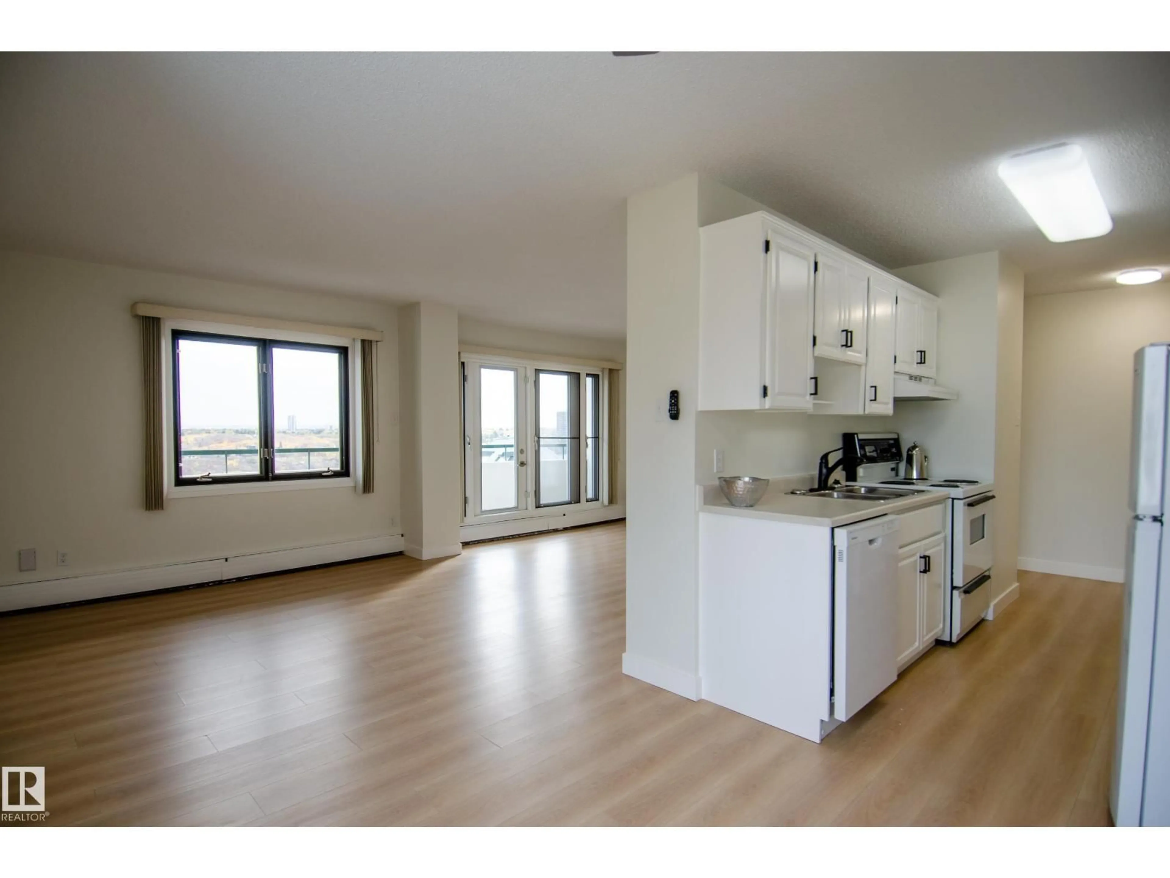 Open concept kitchen, wood/laminate floor for #1403 - 9725 106 ST, Edmonton Alberta T5K1B5