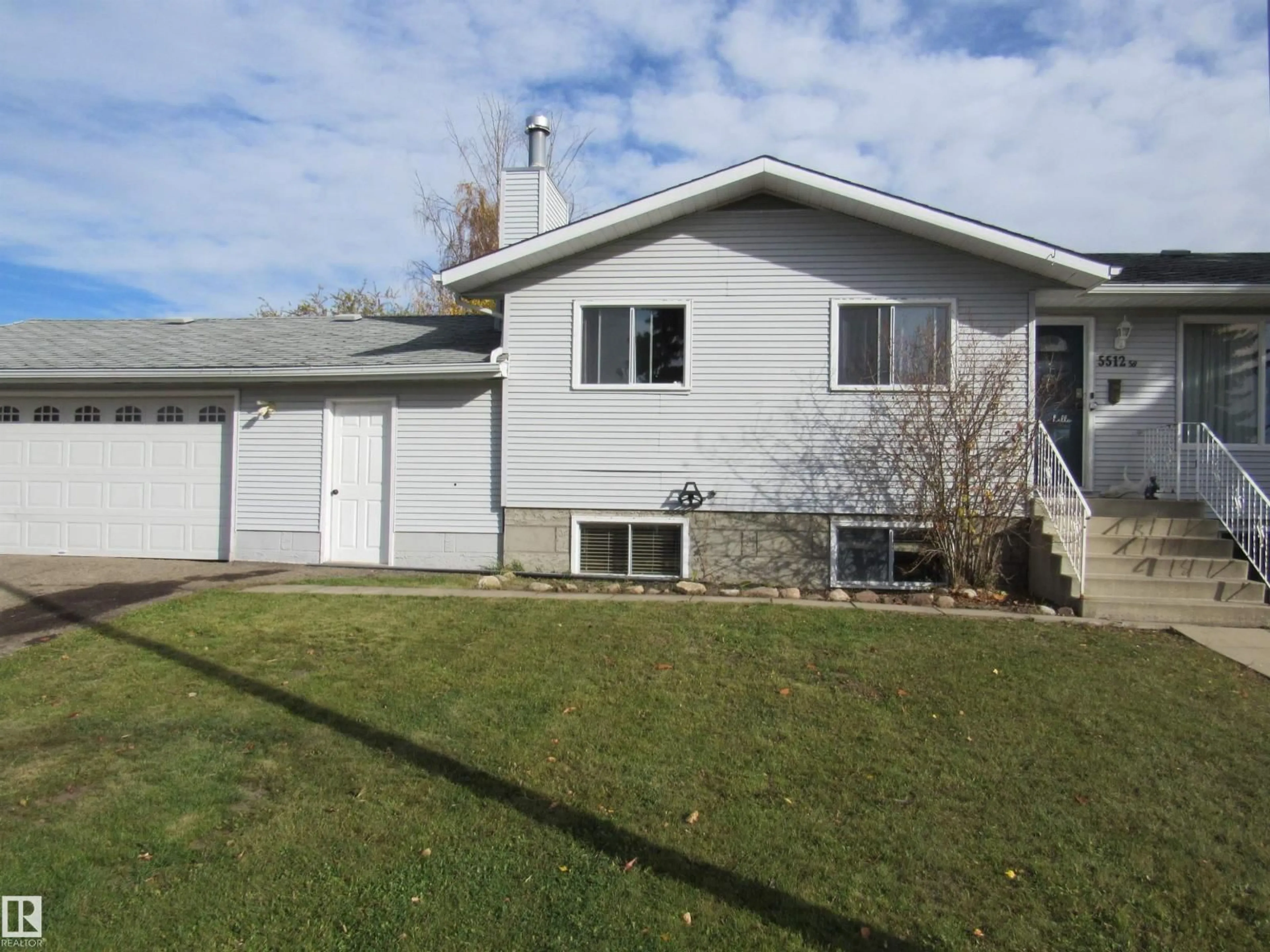 Home with vinyl exterior material, street for 5512 58 AV, Barrhead Alberta T7N1C7