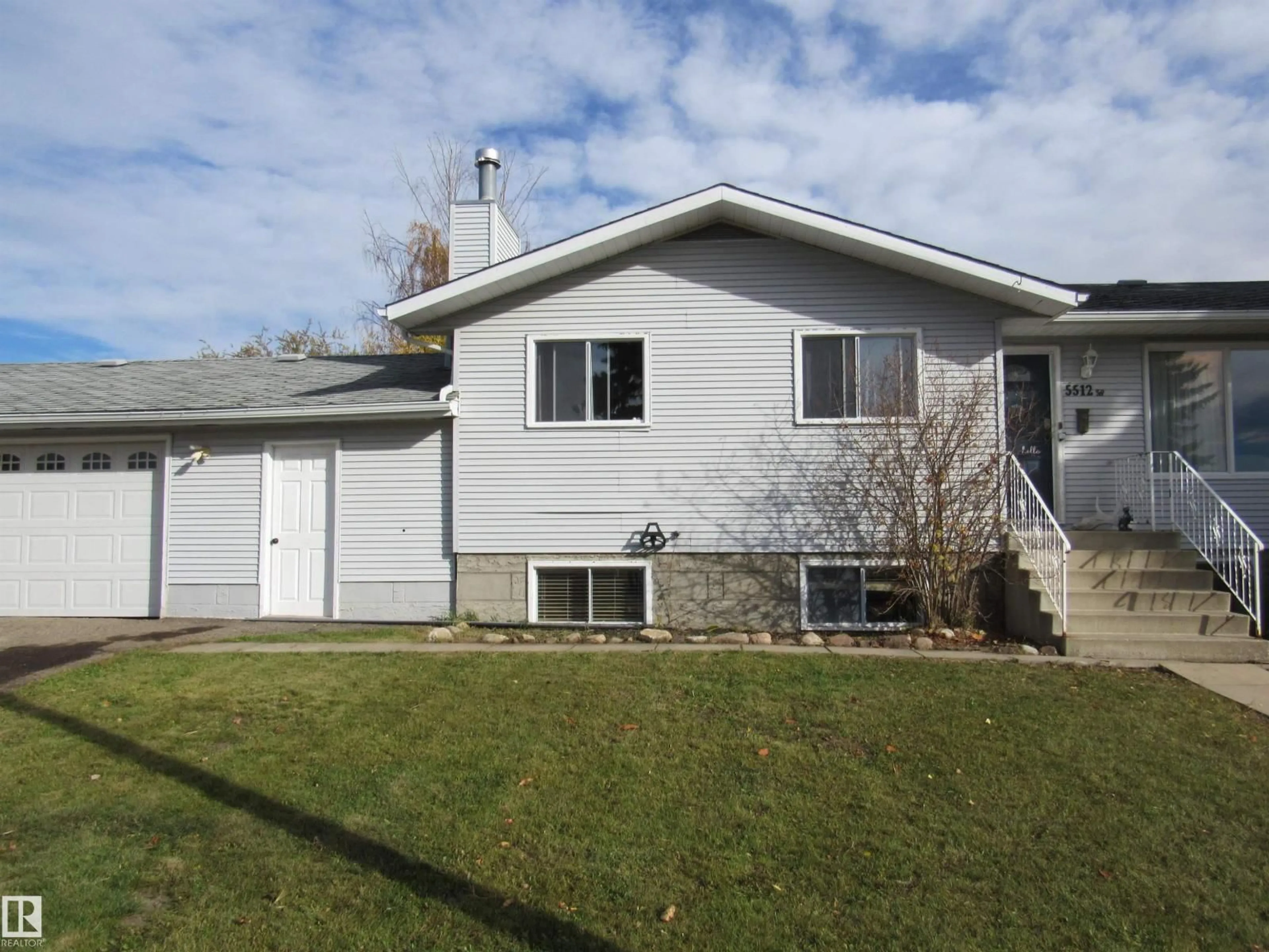 Home with vinyl exterior material, street for 5512 58 AV, Barrhead Alberta T7N1C7