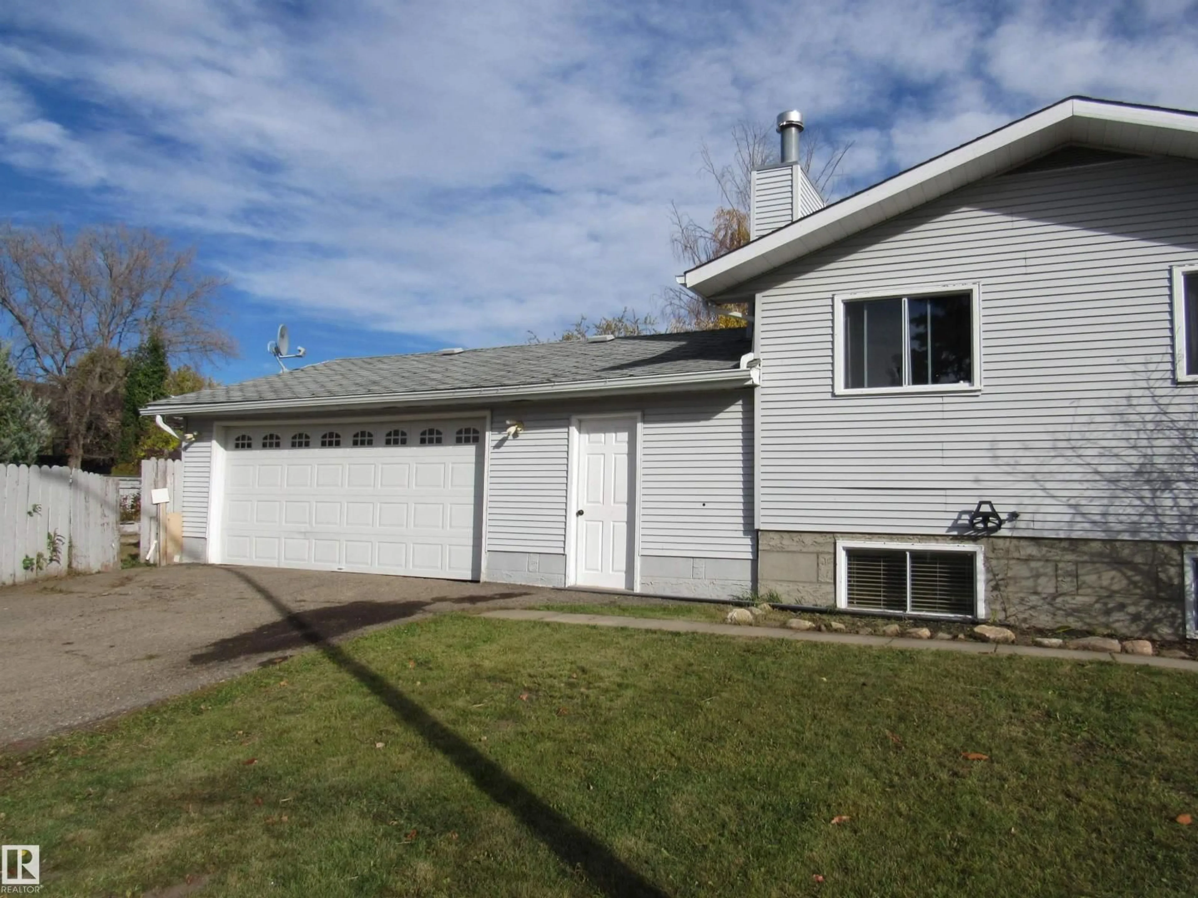 Home with vinyl exterior material, street for 5512 58 AV, Barrhead Alberta T7N1C7