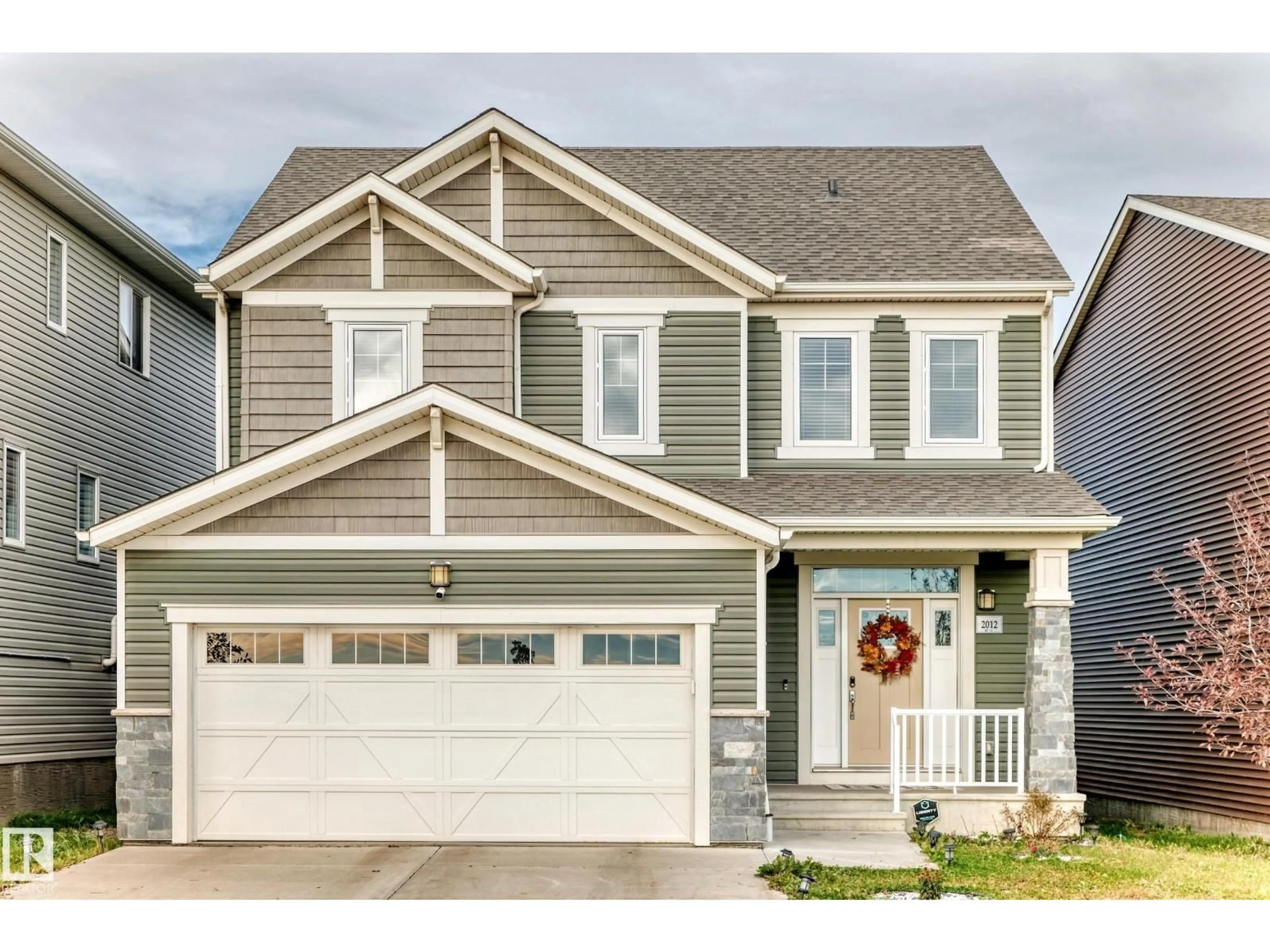 Home with vinyl exterior material, street for NW - 2012 200 ST, Edmonton Alberta T6M0X7