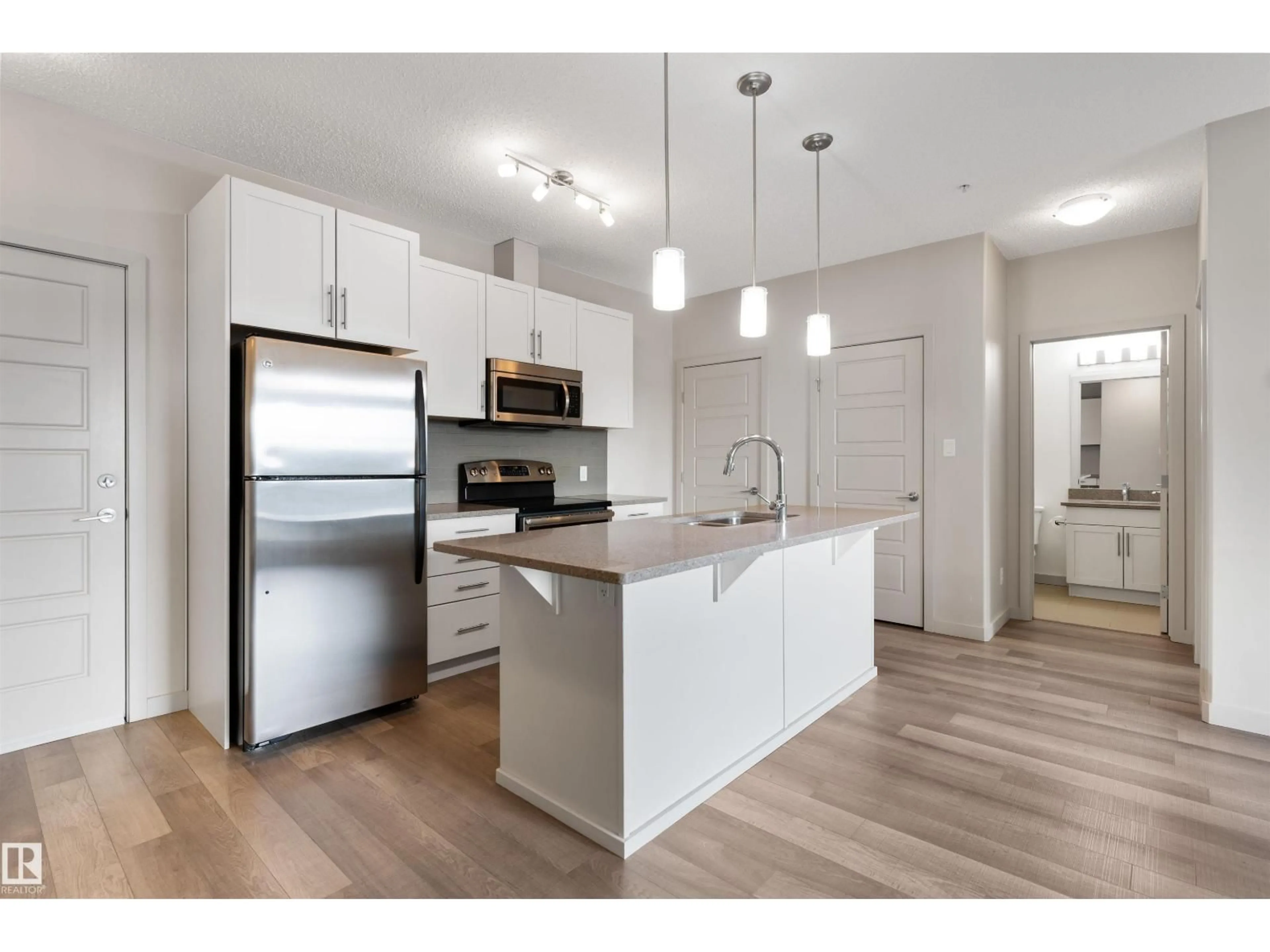 Open concept kitchen, wood/laminate floor for #416 - 1144 ADAMSON DR, Edmonton Alberta T6W2X7