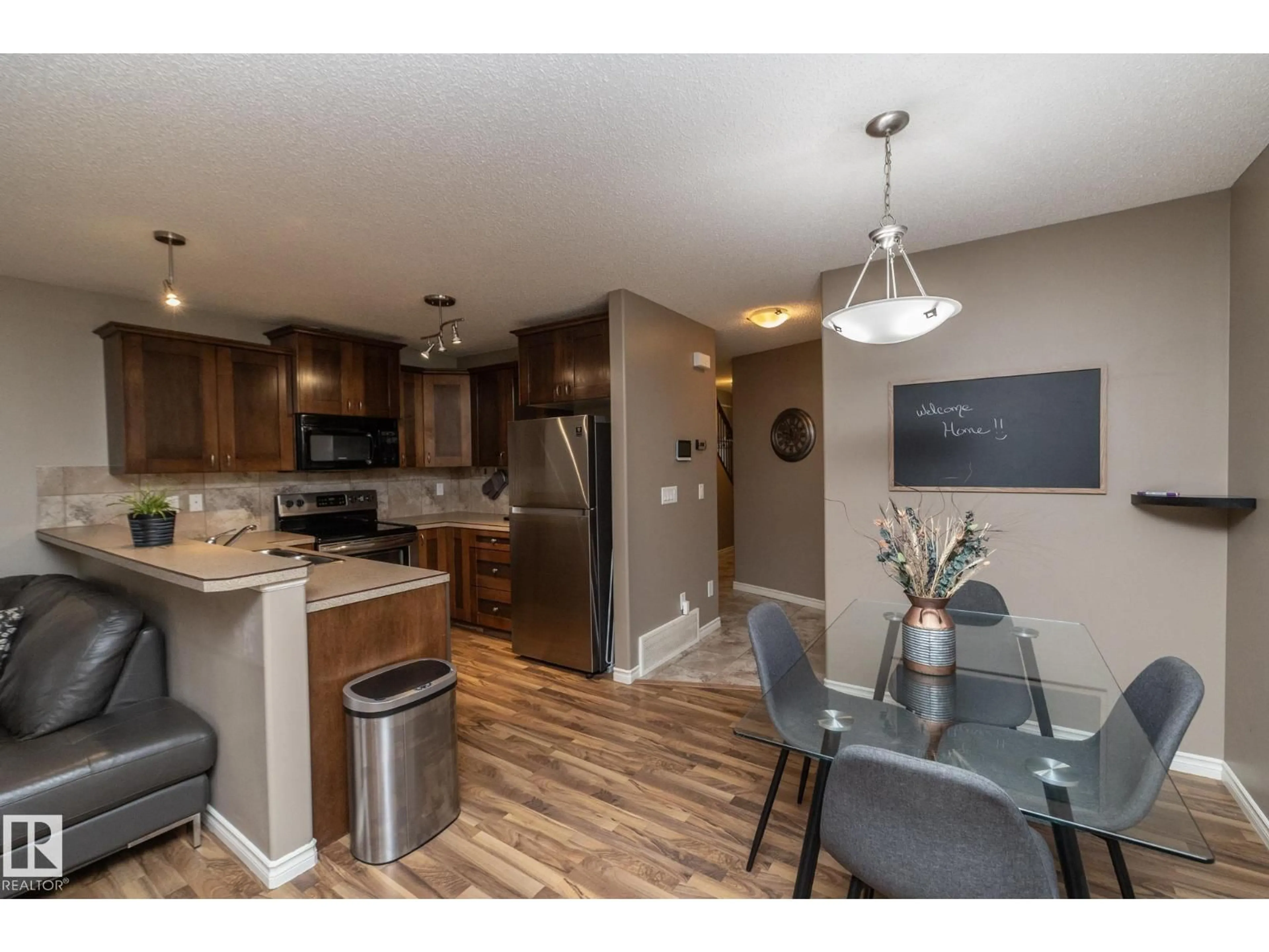 Open concept kitchen, wood/laminate floor for #6 - 10 WOODCREST, Fort Saskatchewan Alberta T8L0C7