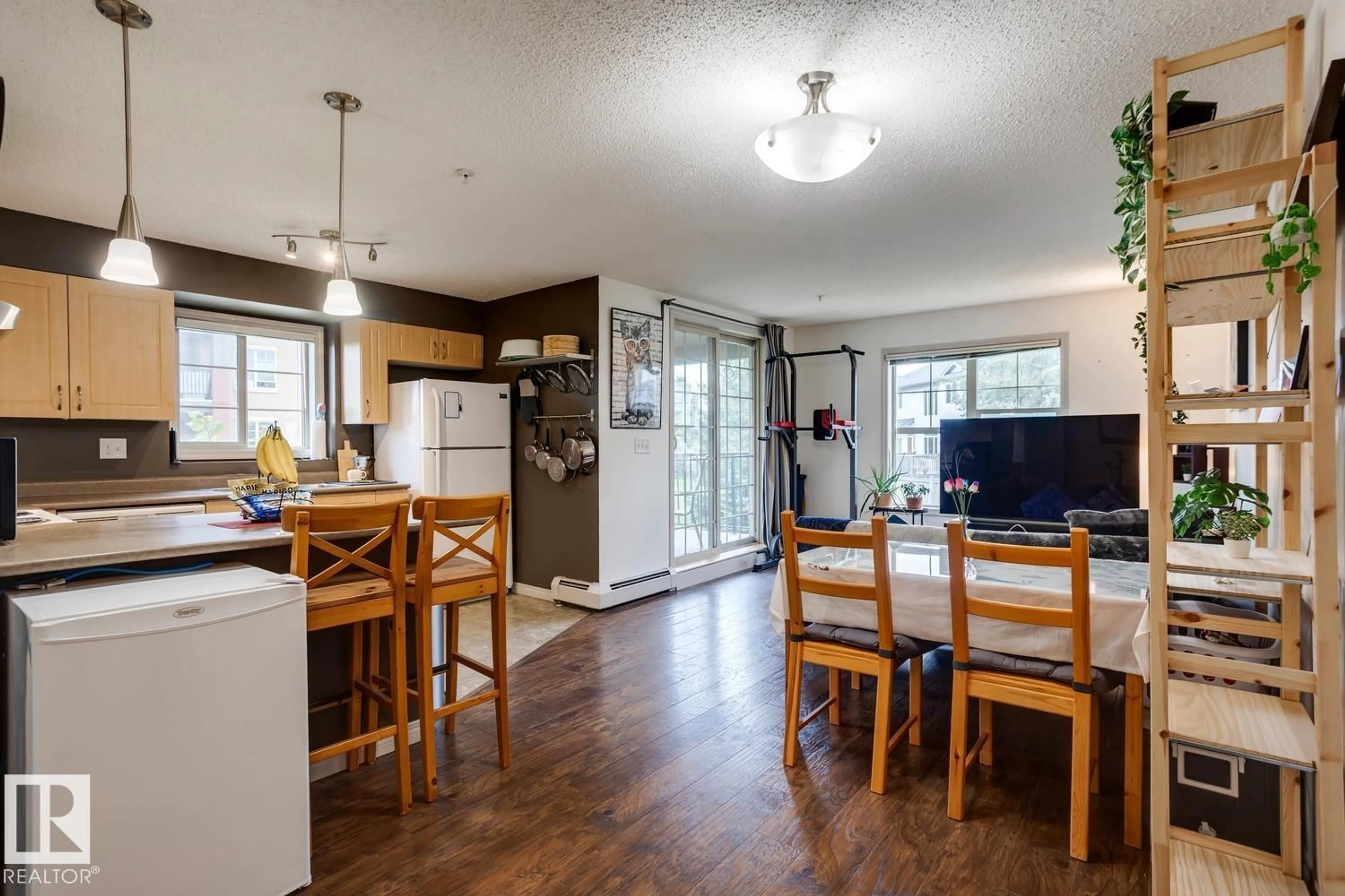 Open concept kitchen, wood/laminate floor for 11449 - 218 ELLERSLIE RD SW, Edmonton Alberta T6W1T2