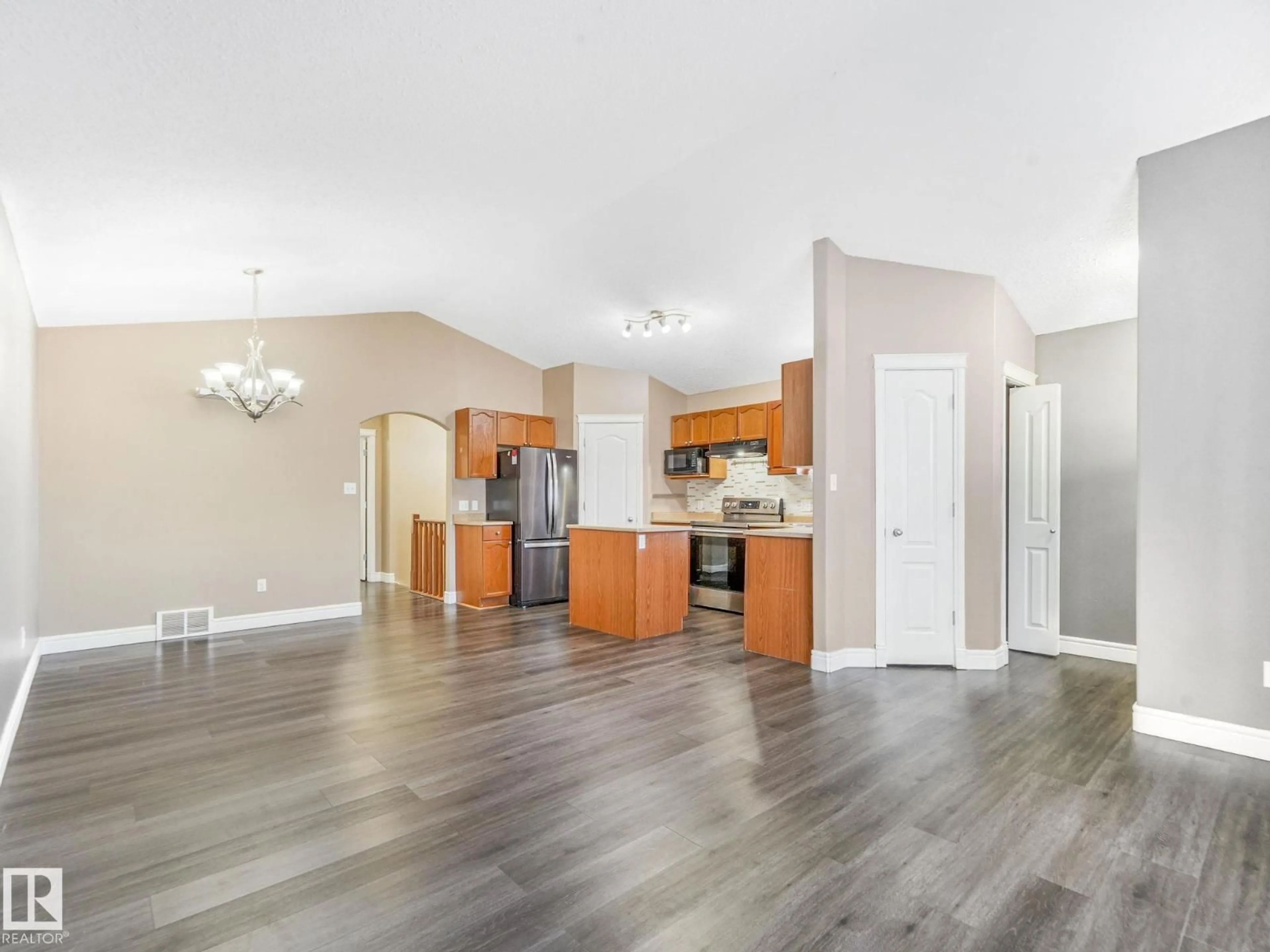Open concept kitchen, wood/laminate floor for 238 AVENA CI, Leduc Alberta T9E0L8