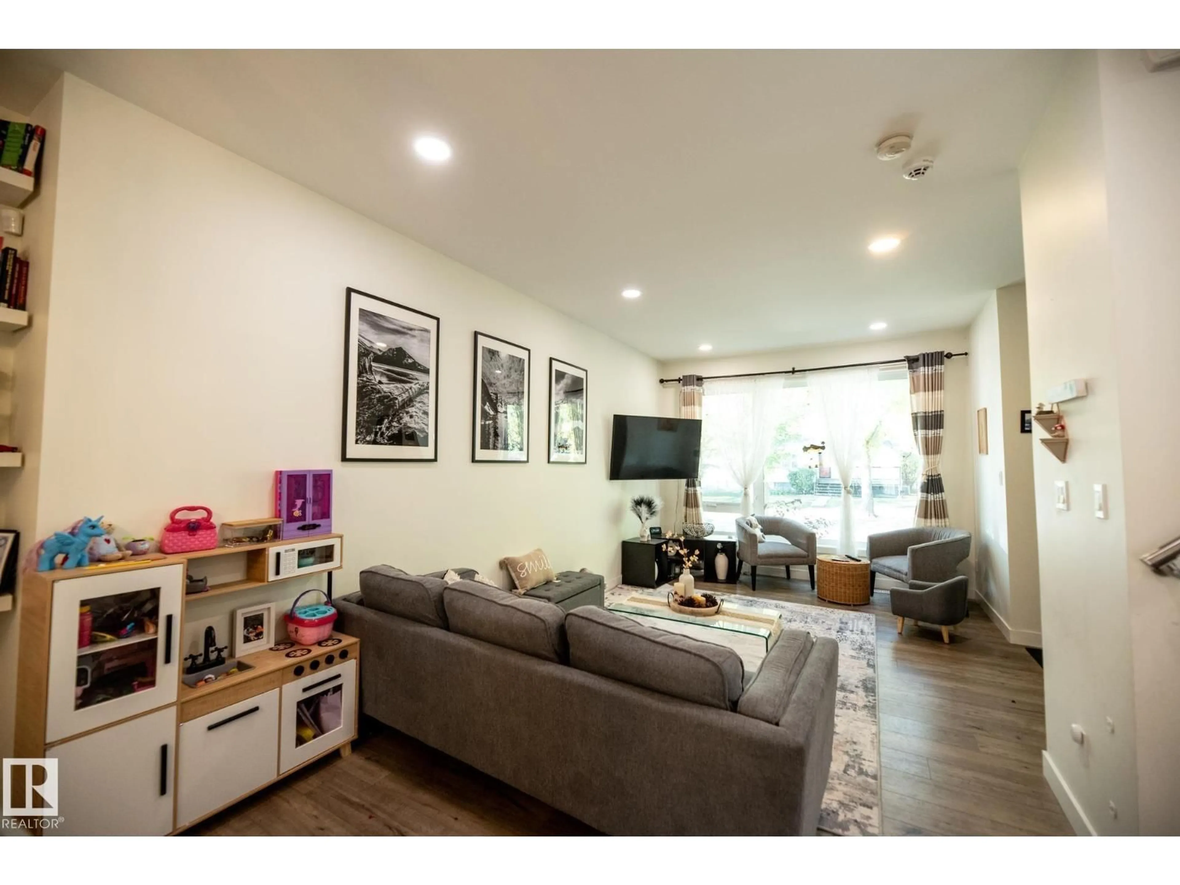 Living room with furniture, wood/laminate floor for NW - 12939 114 ST, Edmonton Alberta T5E5C7