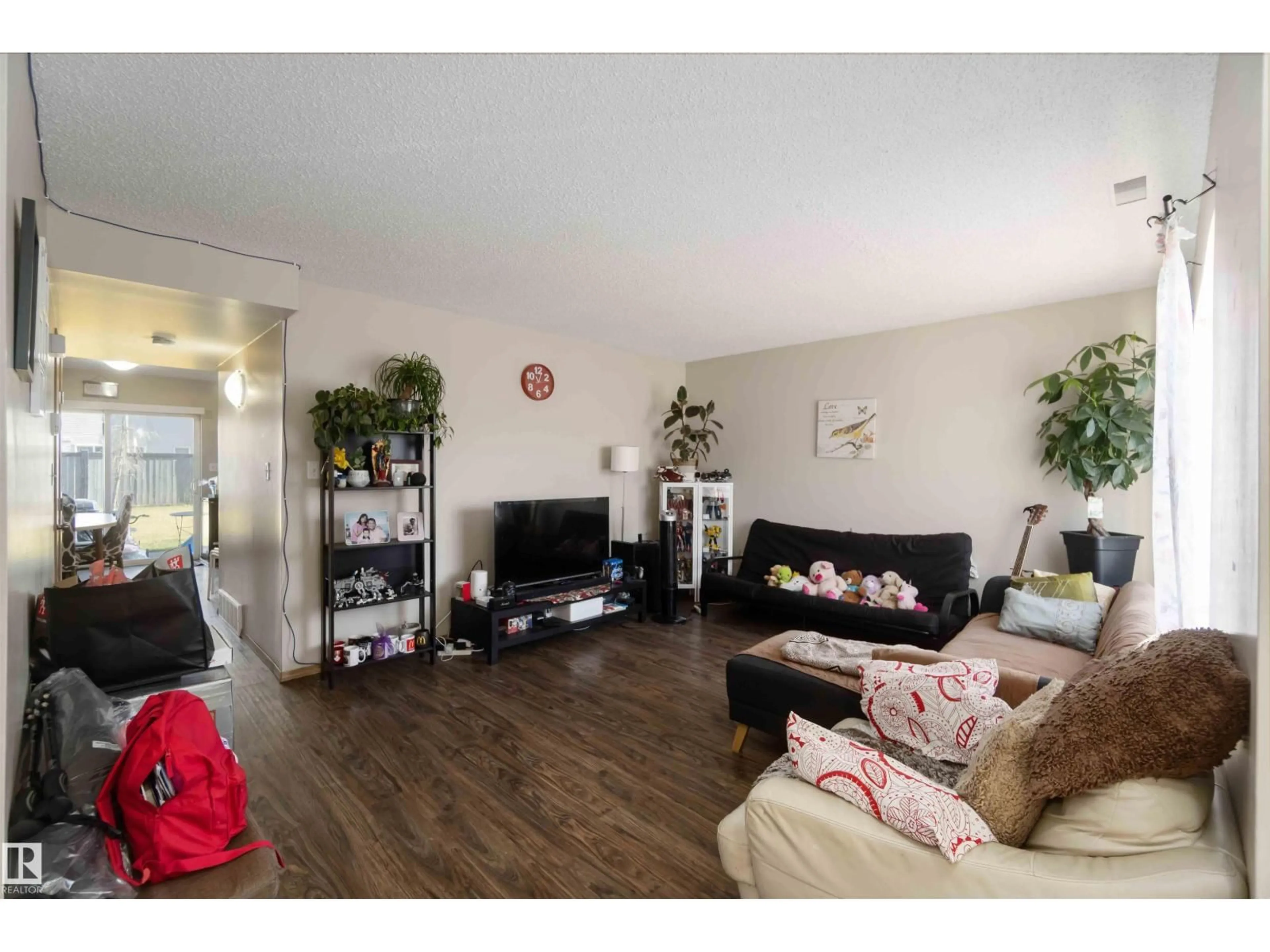 Living room with furniture, wood/laminate floor for 118 180 BRIDGEPORT BV, Leduc Alberta T9E8S1