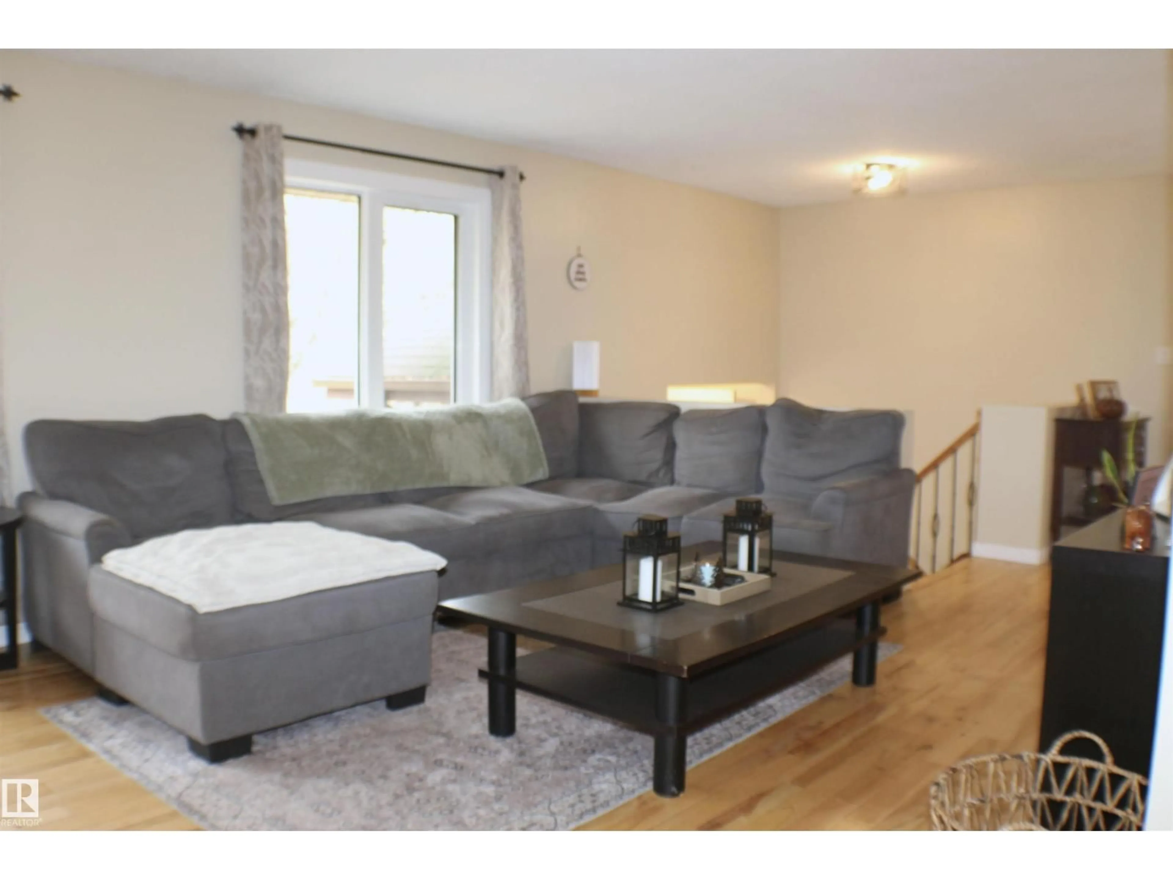 Living room with furniture, wood/laminate floor for 170 51049 RGE ROAD 214, Rural Strathcona County Alberta T8E1G7