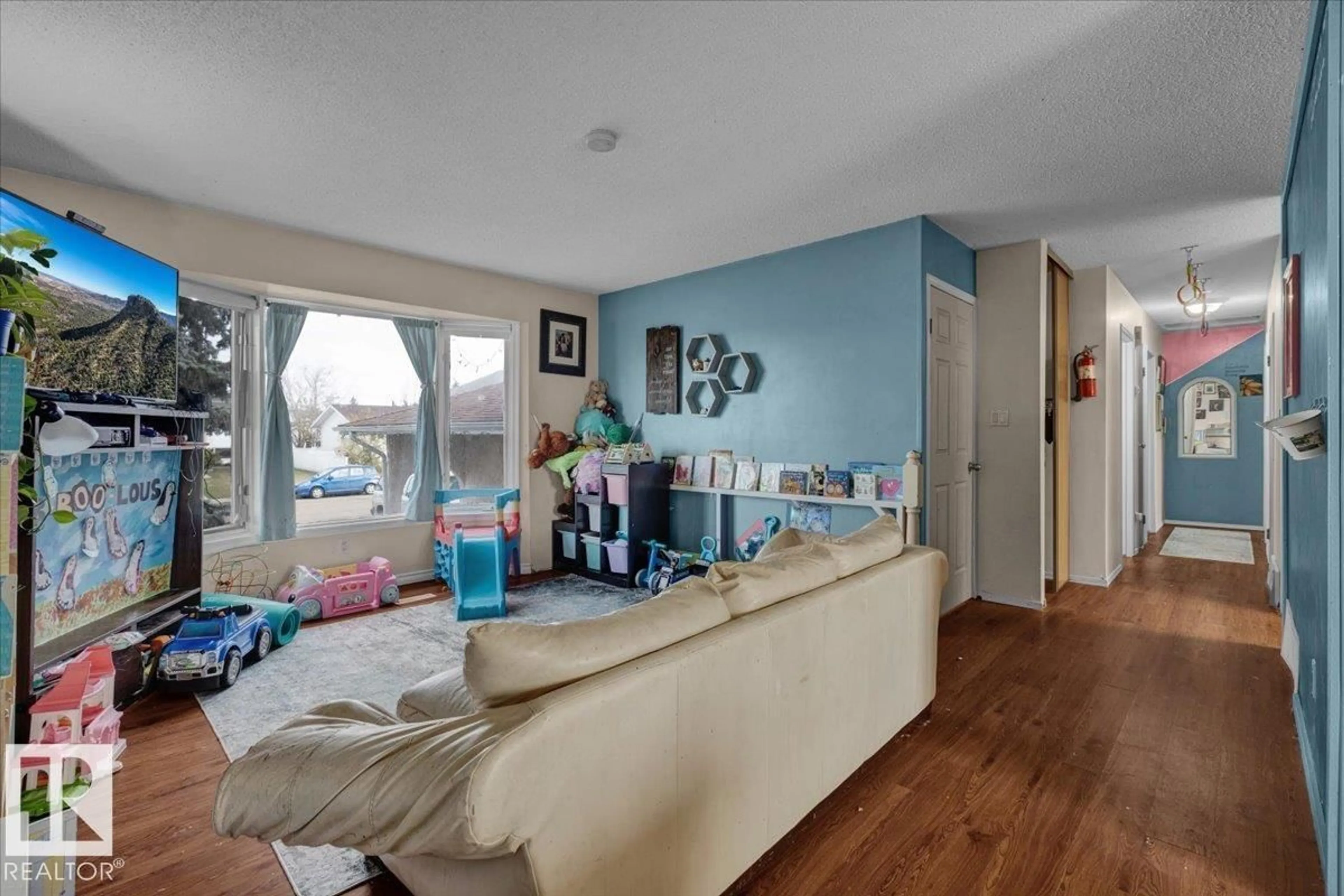 Living room with furniture, wood/laminate floor for 5219 45 ST, Tofield Alberta T0B4J0