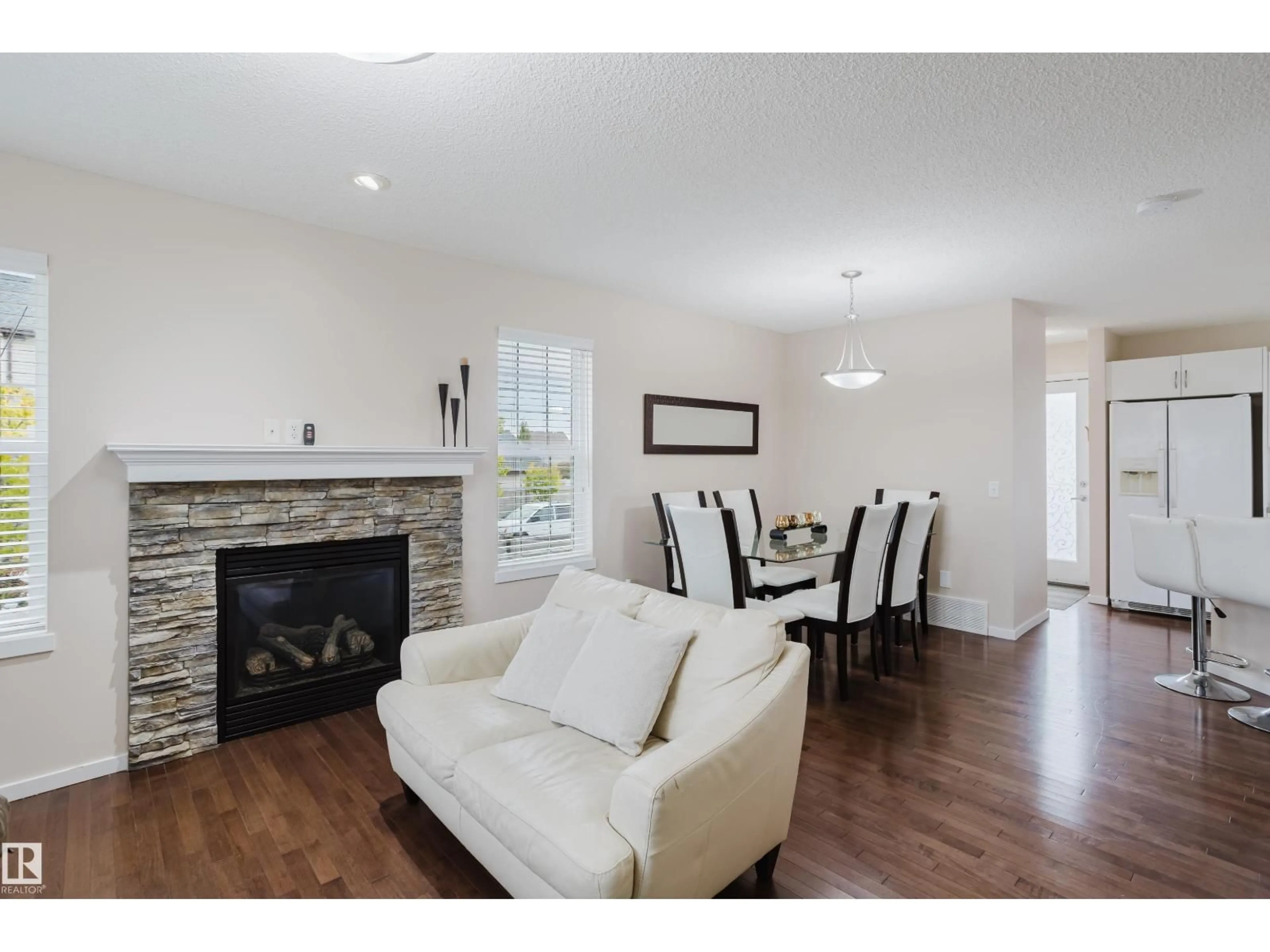 Living room with furniture, wood/laminate floor for 6028 3 AV SW, Edmonton Alberta T6X0E6
