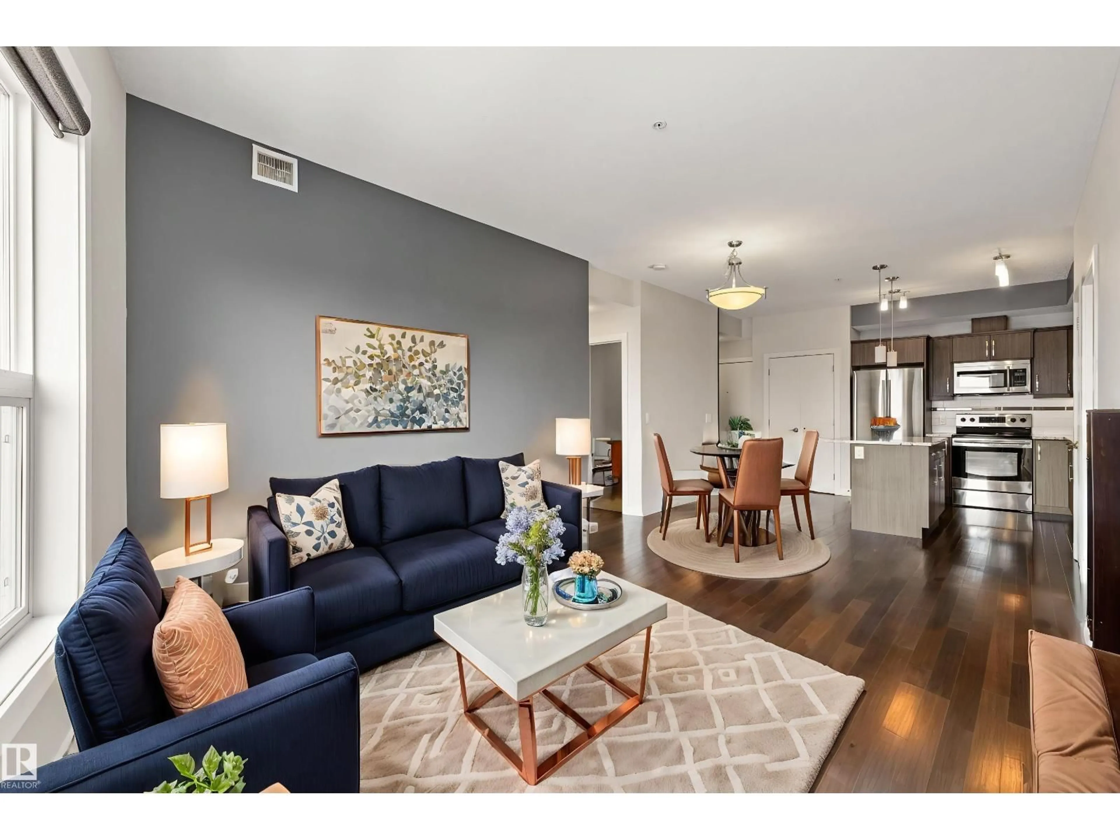 Living room with furniture, wood/laminate floor for 412 10523 123 ST NW, Edmonton Alberta T5N1N9