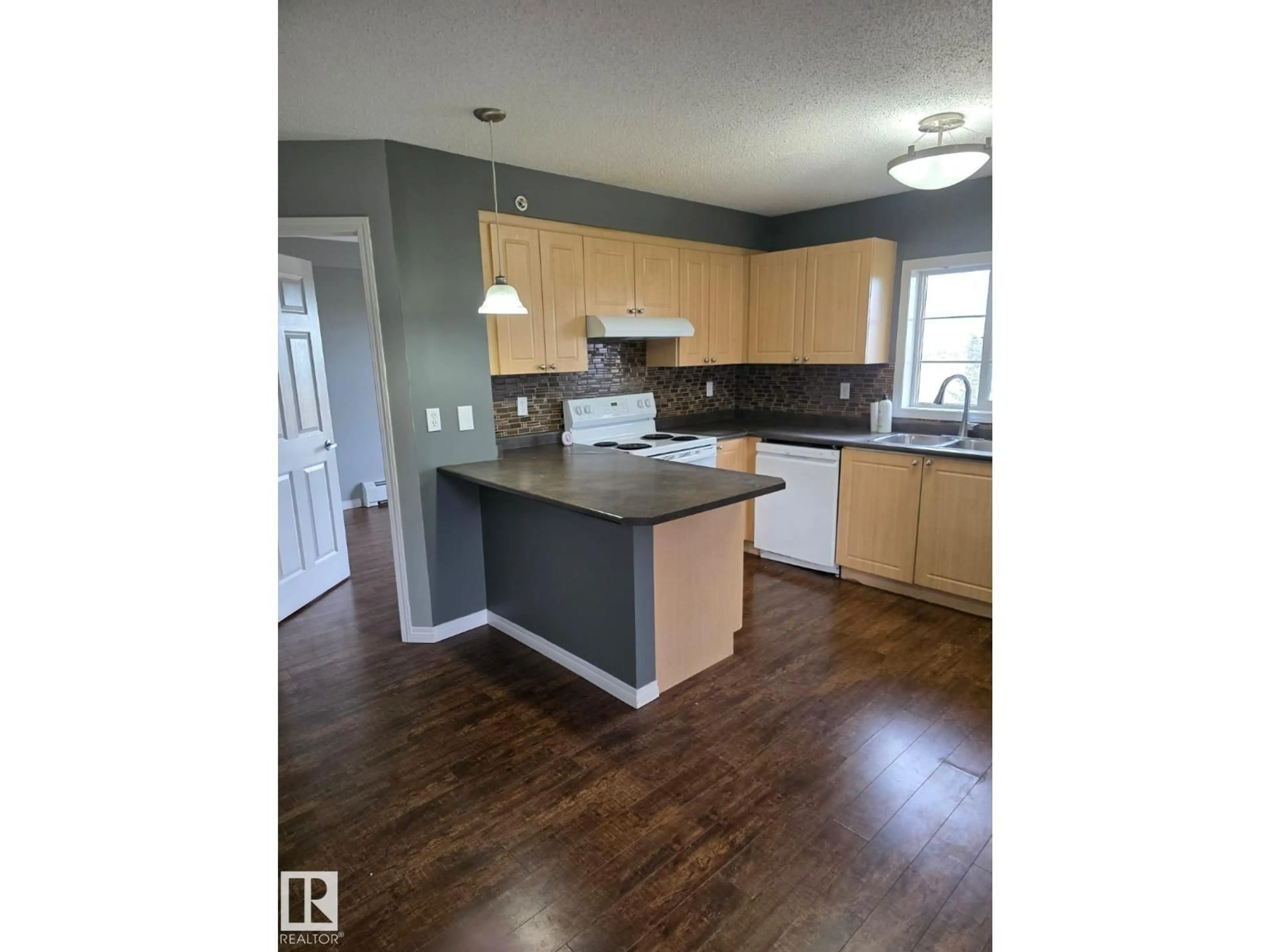 Open concept kitchen, wood/laminate floor for #402 - 622 MCALLISTER LO, Edmonton Alberta T6W1N2