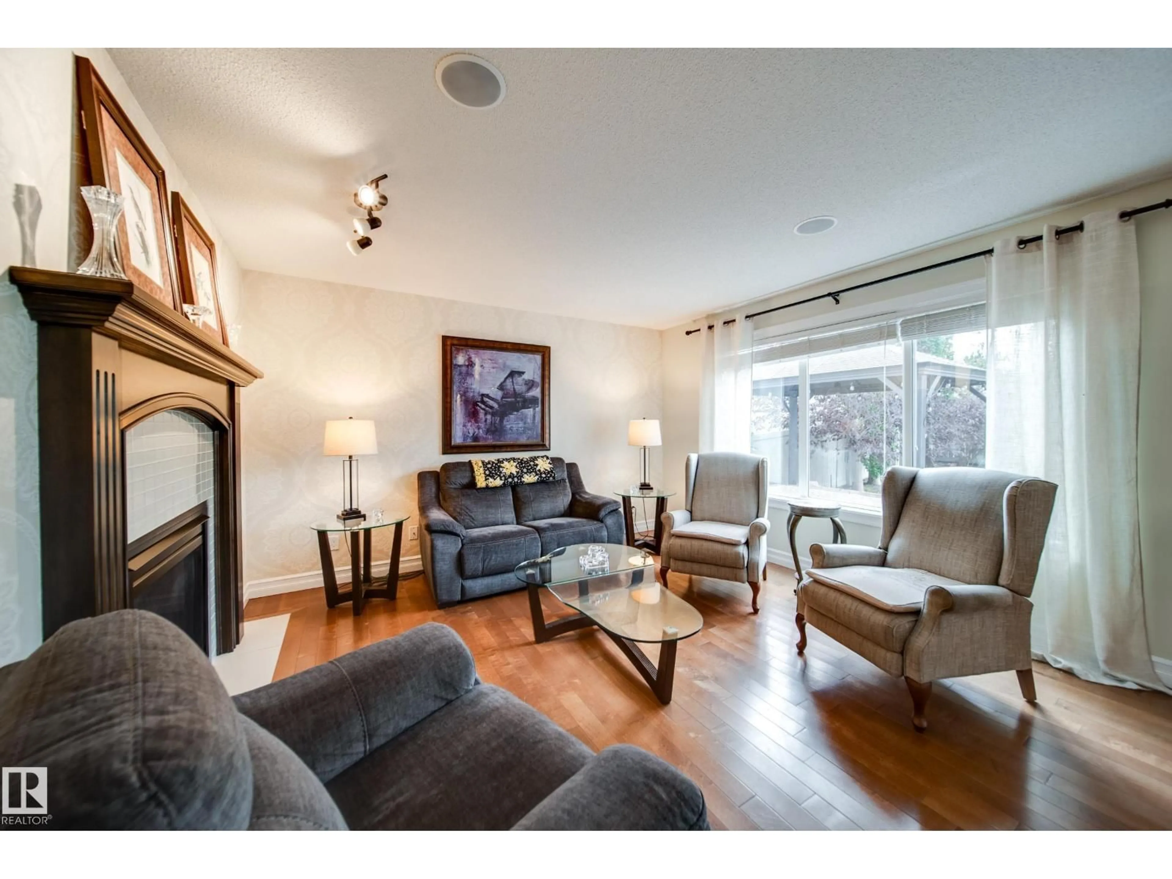 Living room with furniture, wood/laminate floor for 722 CAINE BV, Edmonton Alberta T6W0R4