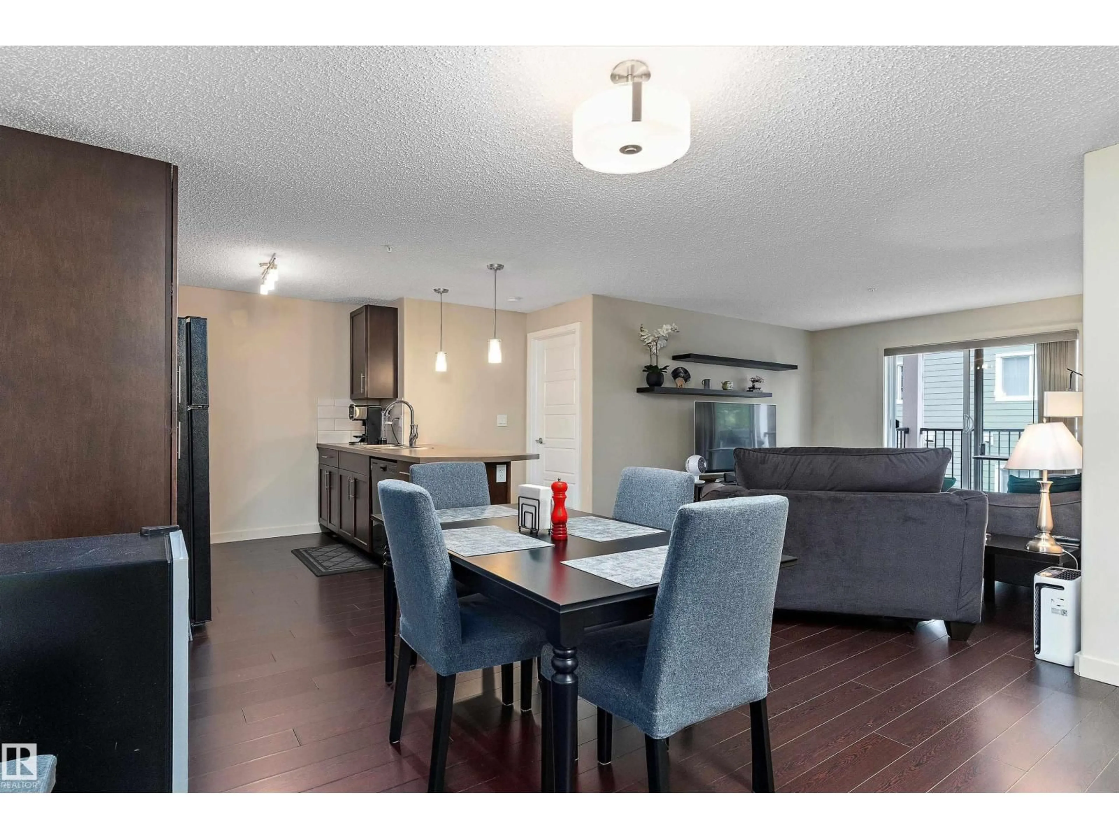 Open concept kitchen, wood/laminate floor for 6076 - 238 SCHONSEE WY, Edmonton Alberta T5Z0K8