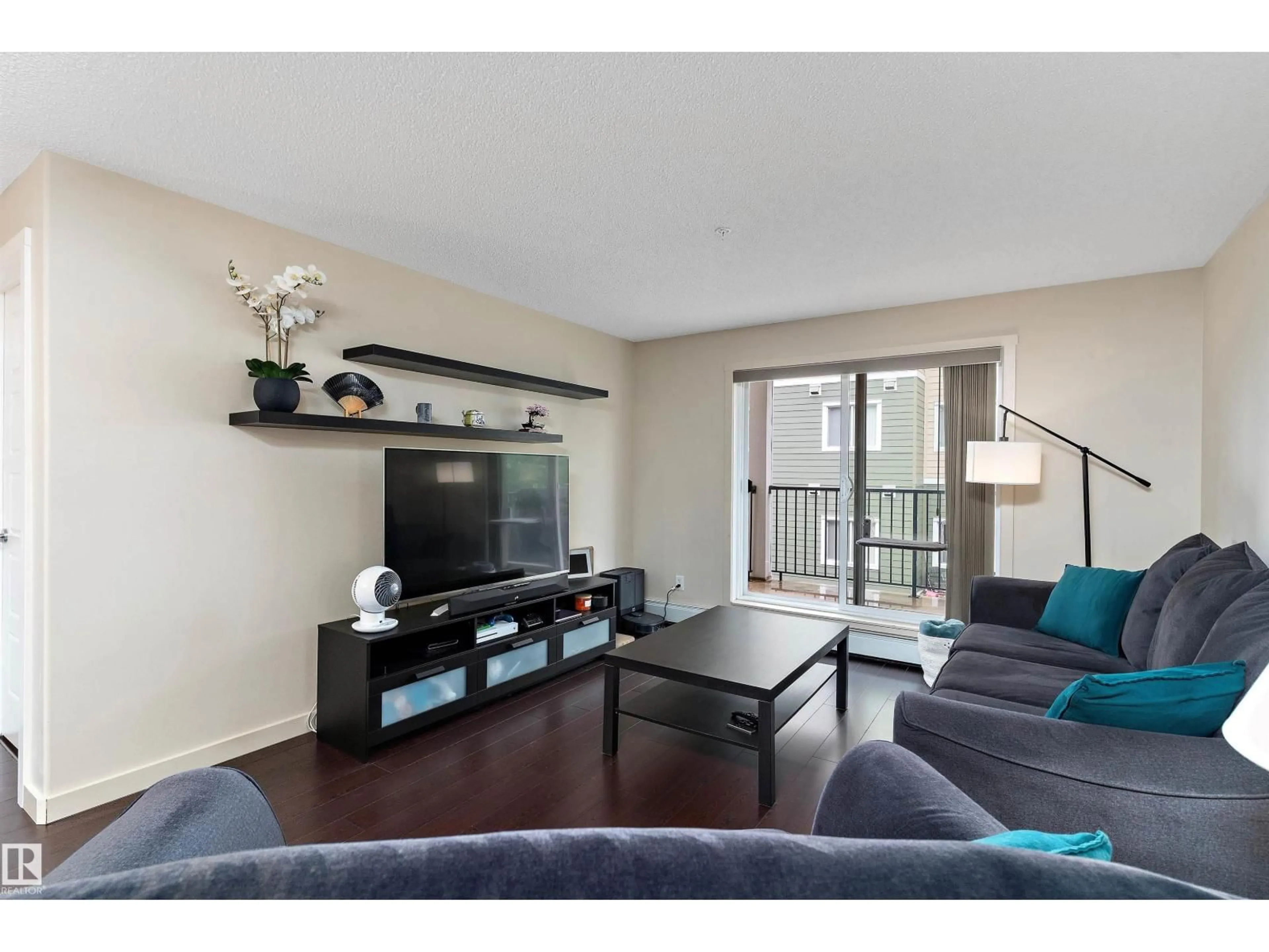 Living room with furniture, wood/laminate floor for 6076 - 238 SCHONSEE WY, Edmonton Alberta T5Z0K8
