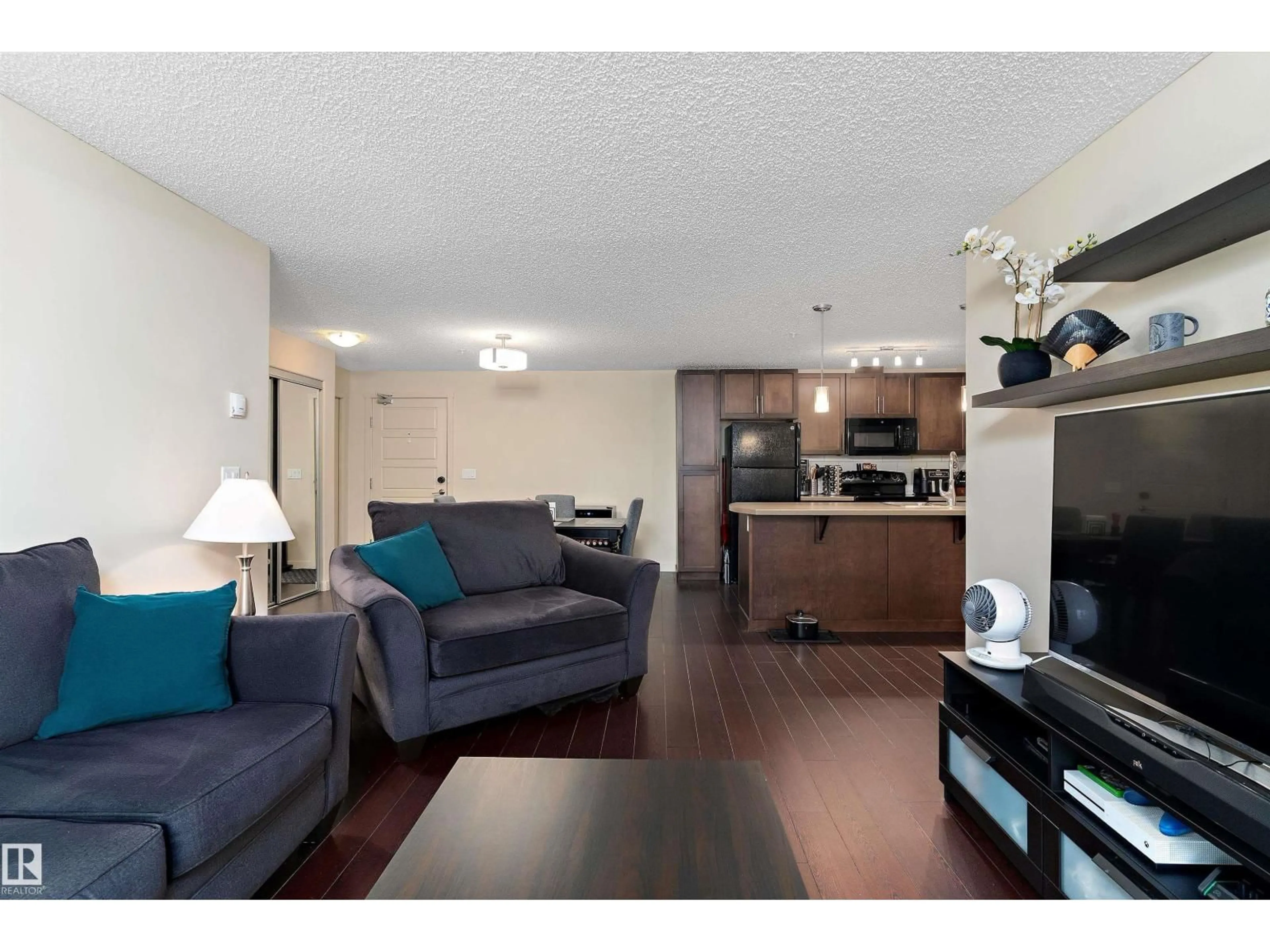 Living room with furniture, wood/laminate floor for 6076 - 238 SCHONSEE WY, Edmonton Alberta T5Z0K8