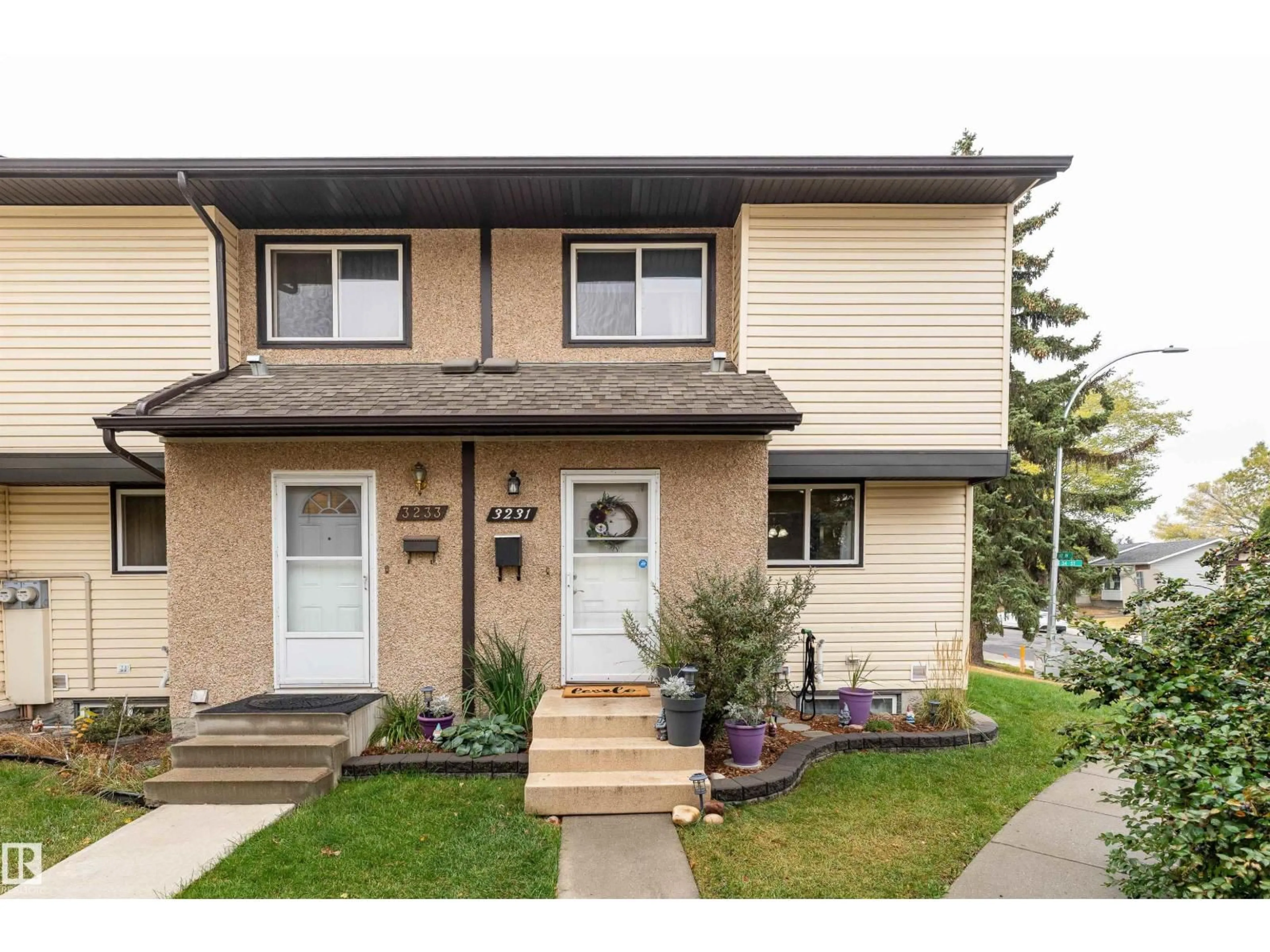 Home with vinyl exterior material, street for 3231 142 AV, Edmonton Alberta T5Y1H9