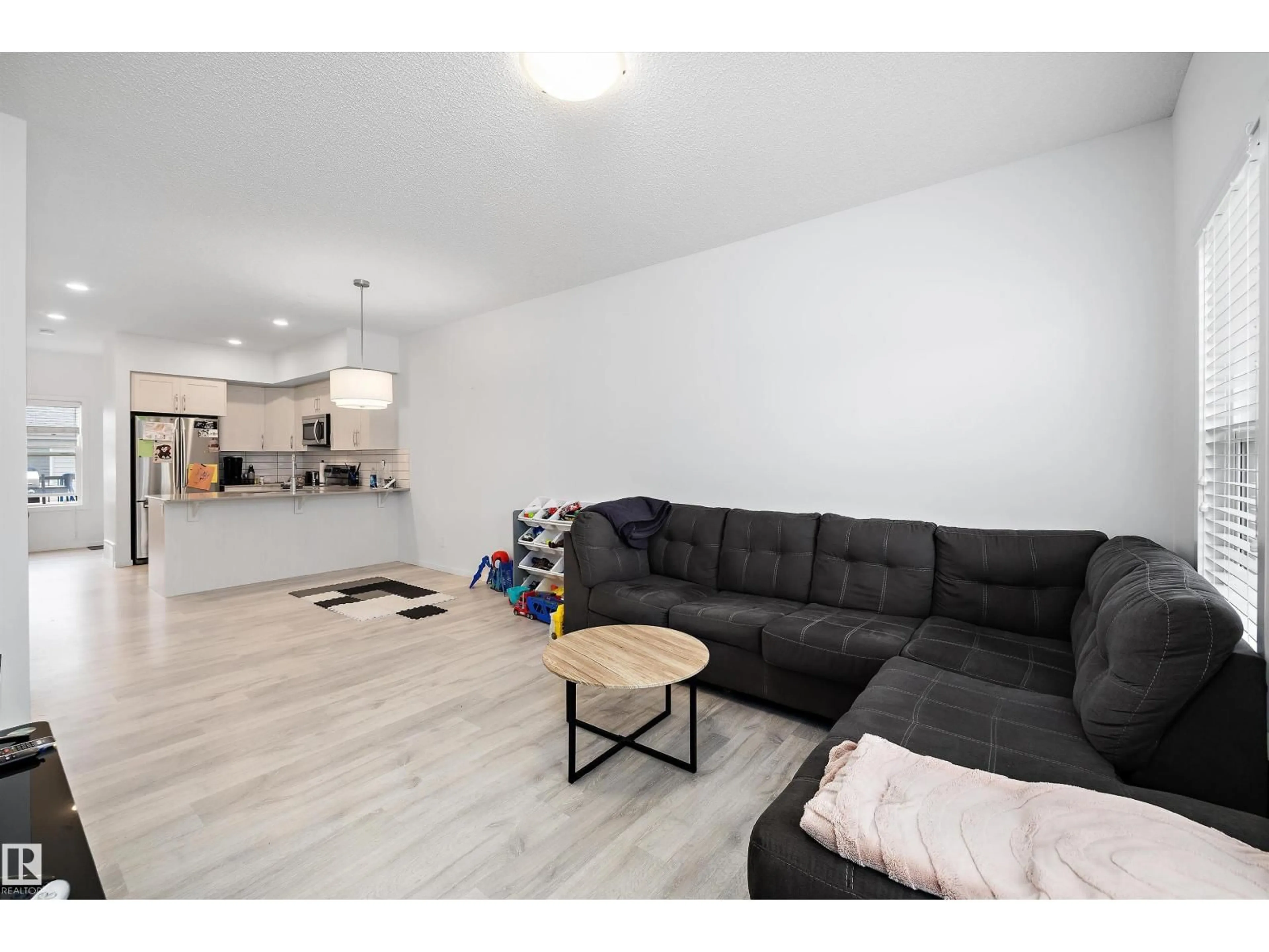 Living room with furniture, wood/laminate floor for 4317 COOKE LN, Edmonton Alberta T6W4M7