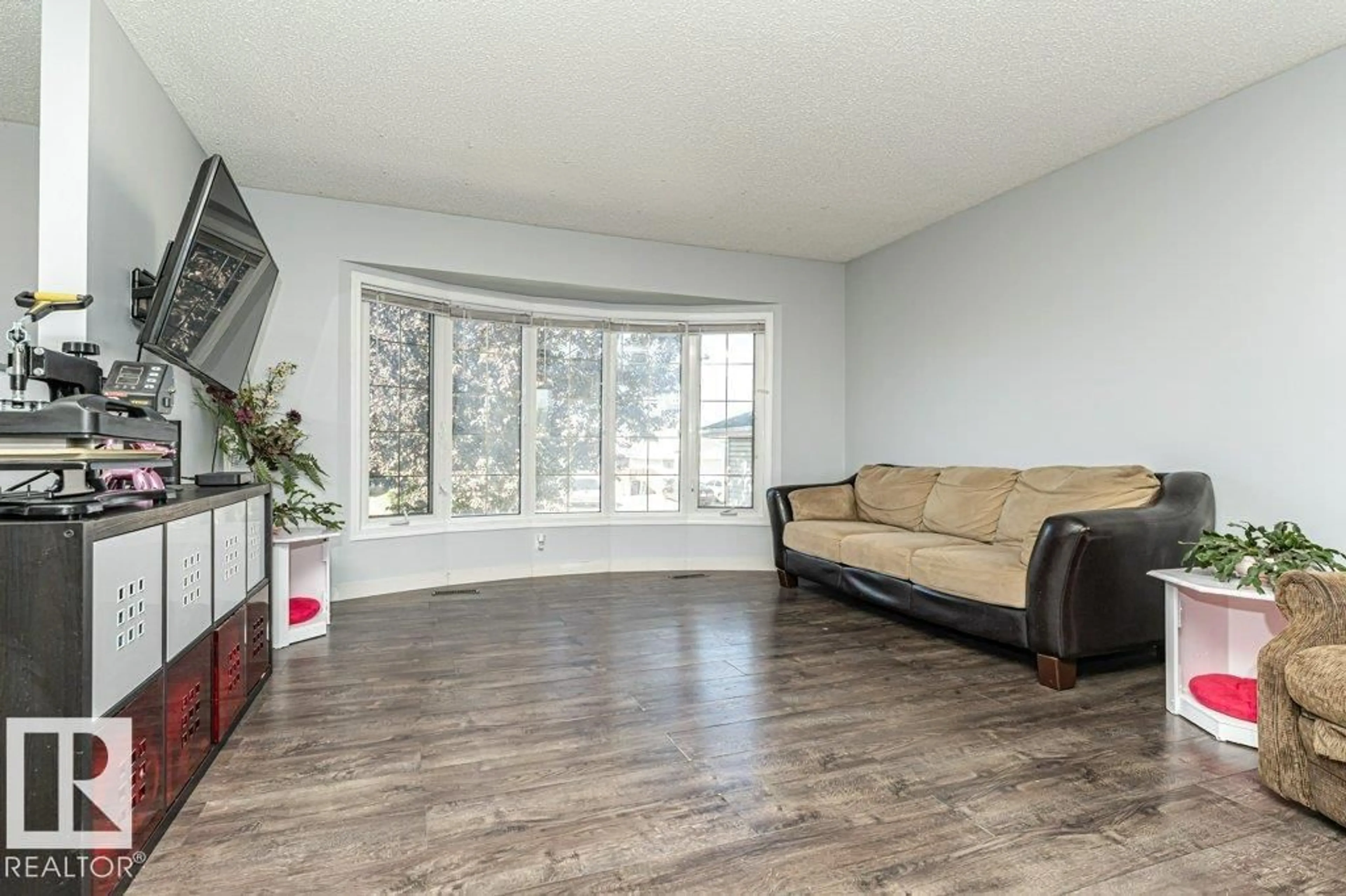 Living room with furniture, wood/laminate floor for 2827 35 ST, Edmonton Alberta T6L5K2