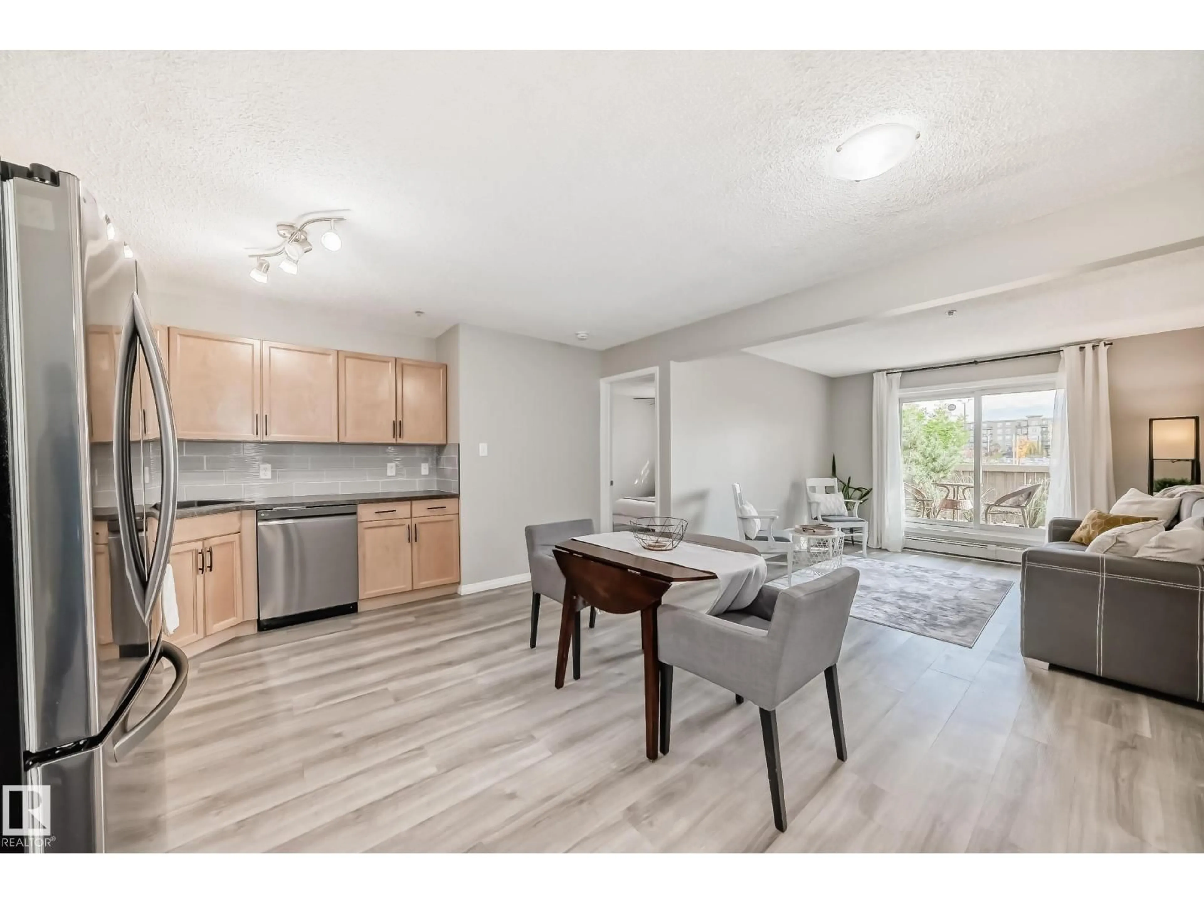 Open concept kitchen, wood/laminate floor for 309 - 118 CLAREVIEW STATION DR, Edmonton Alberta T5Y0C5