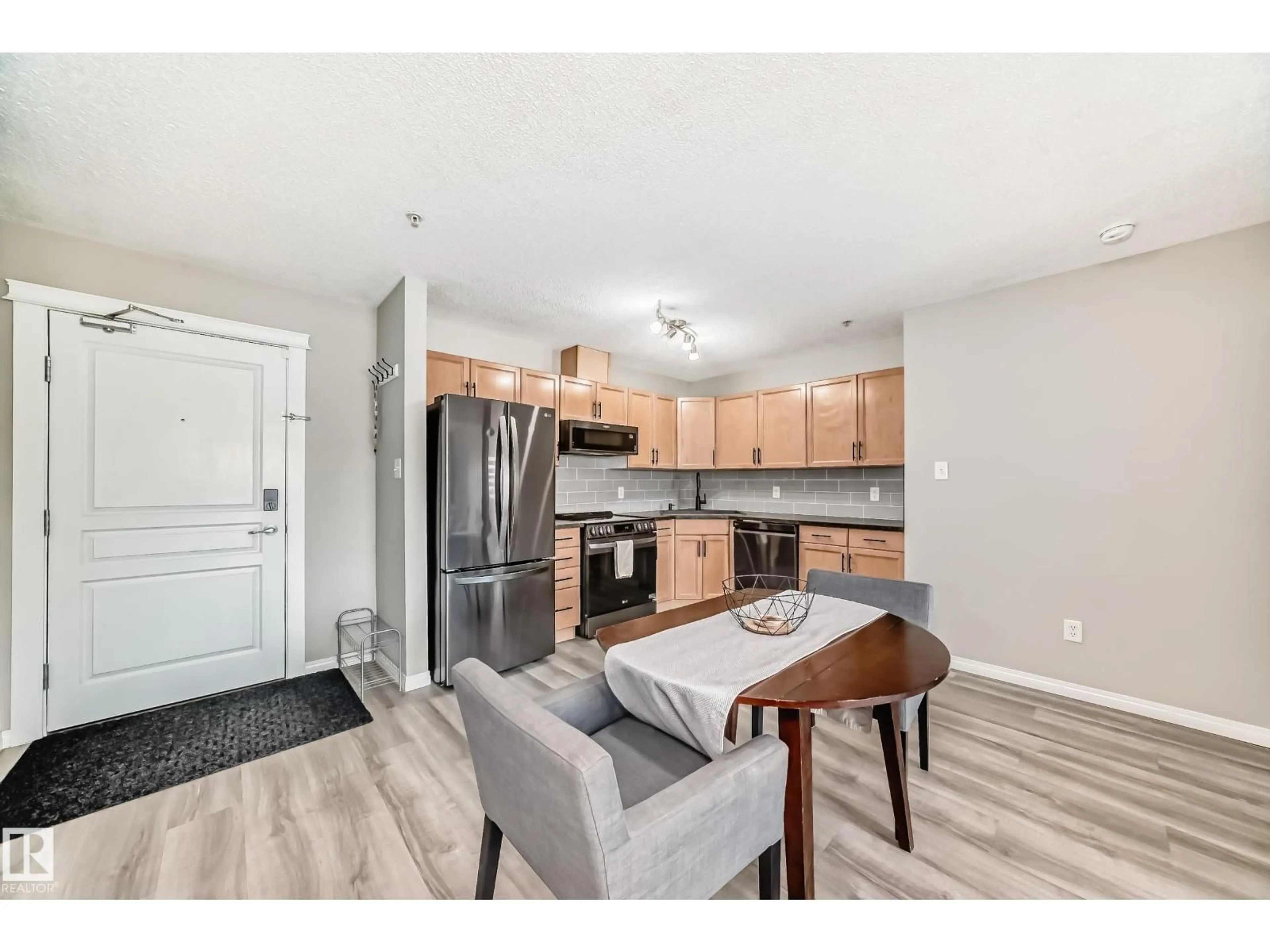 Open concept kitchen, wood/laminate floor for 309 - 118 CLAREVIEW STATION DR, Edmonton Alberta T5Y0C5