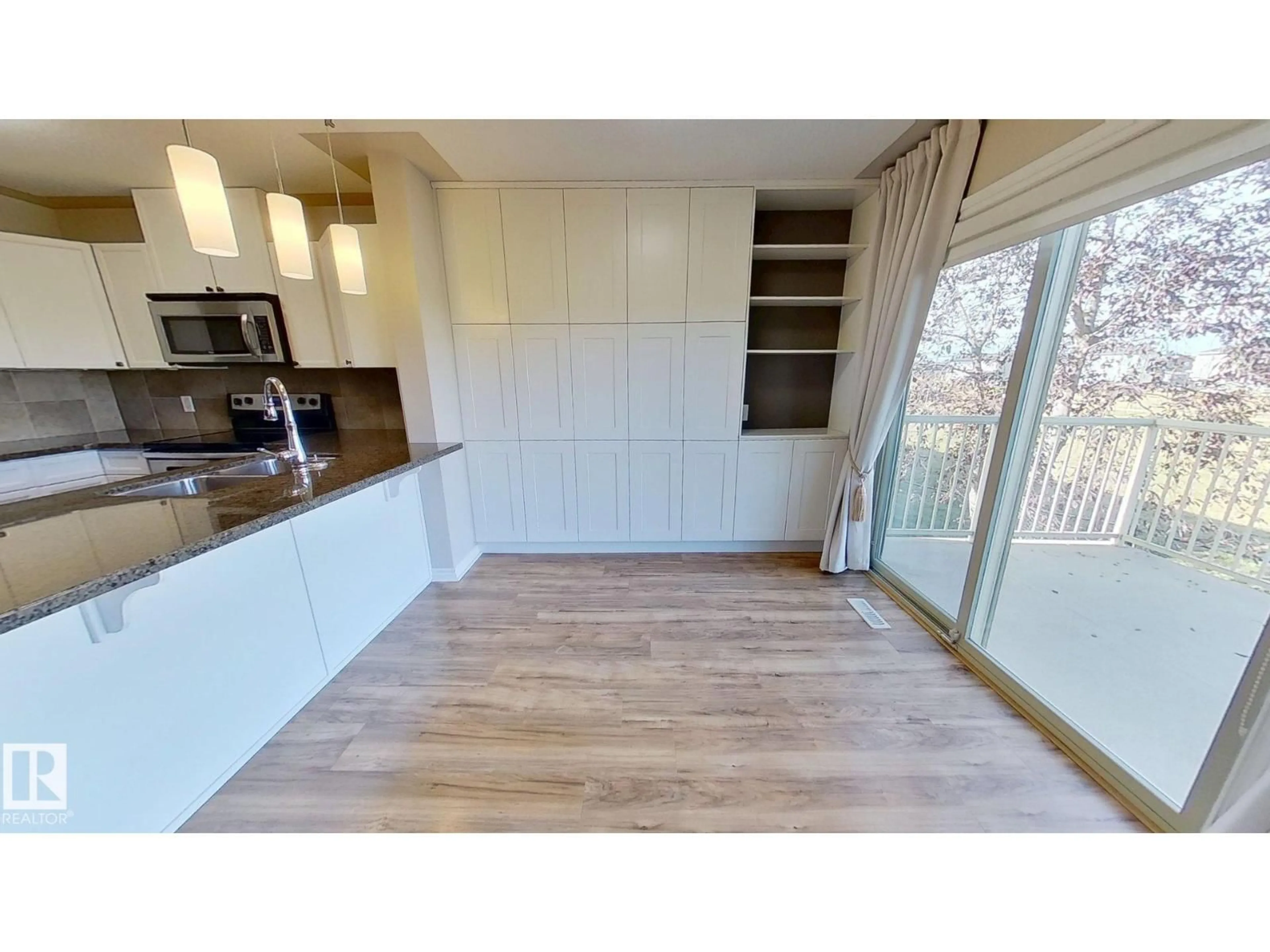 Open concept kitchen, wood/laminate floor for 5420 - 136 GRANT MACEWAN BV, Leduc Alberta T9E0M1