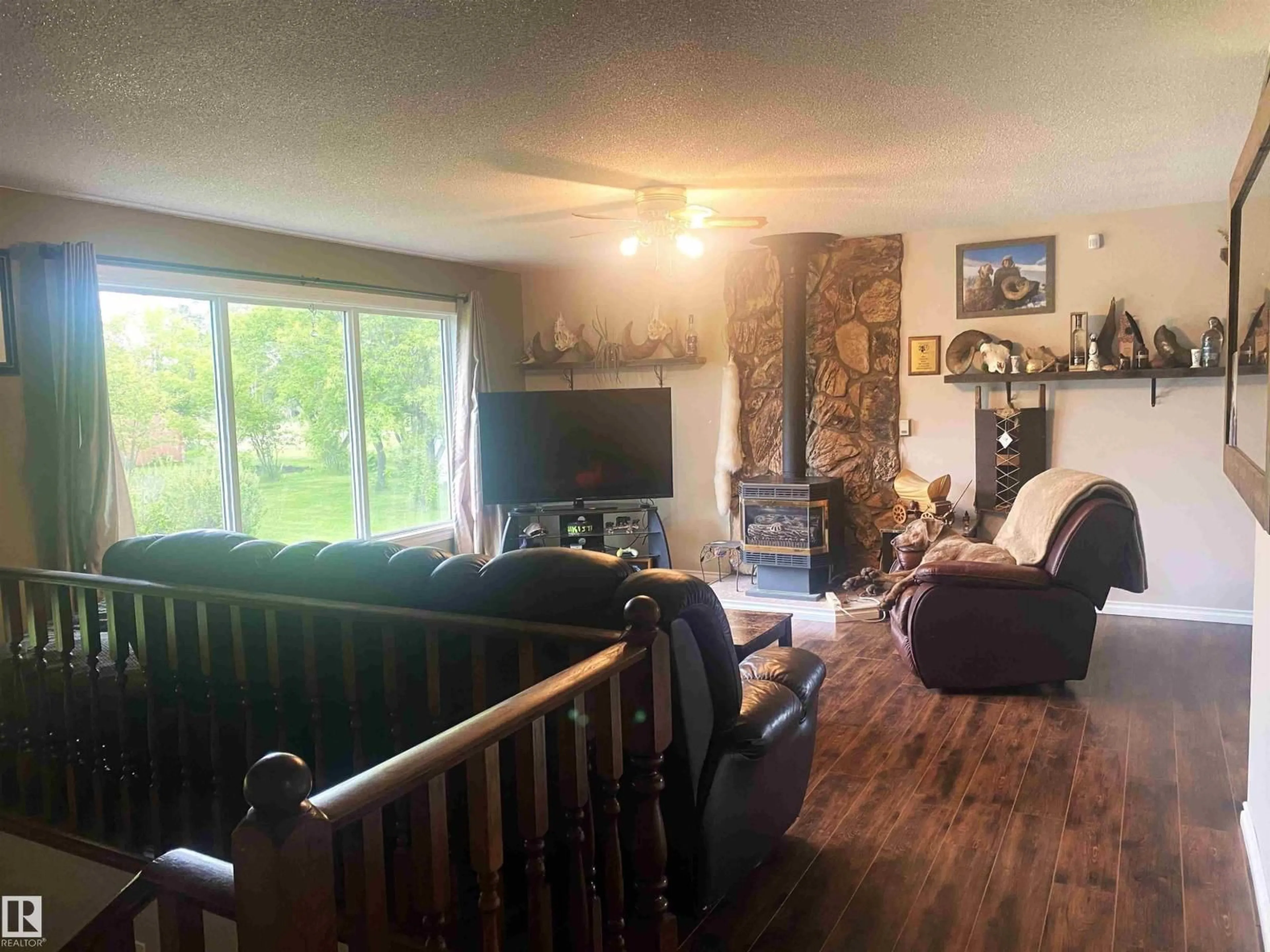 Living room with furniture, wood/laminate floor for 48214 RGE RD 42, Rural Brazeau County Alberta T0C0P0
