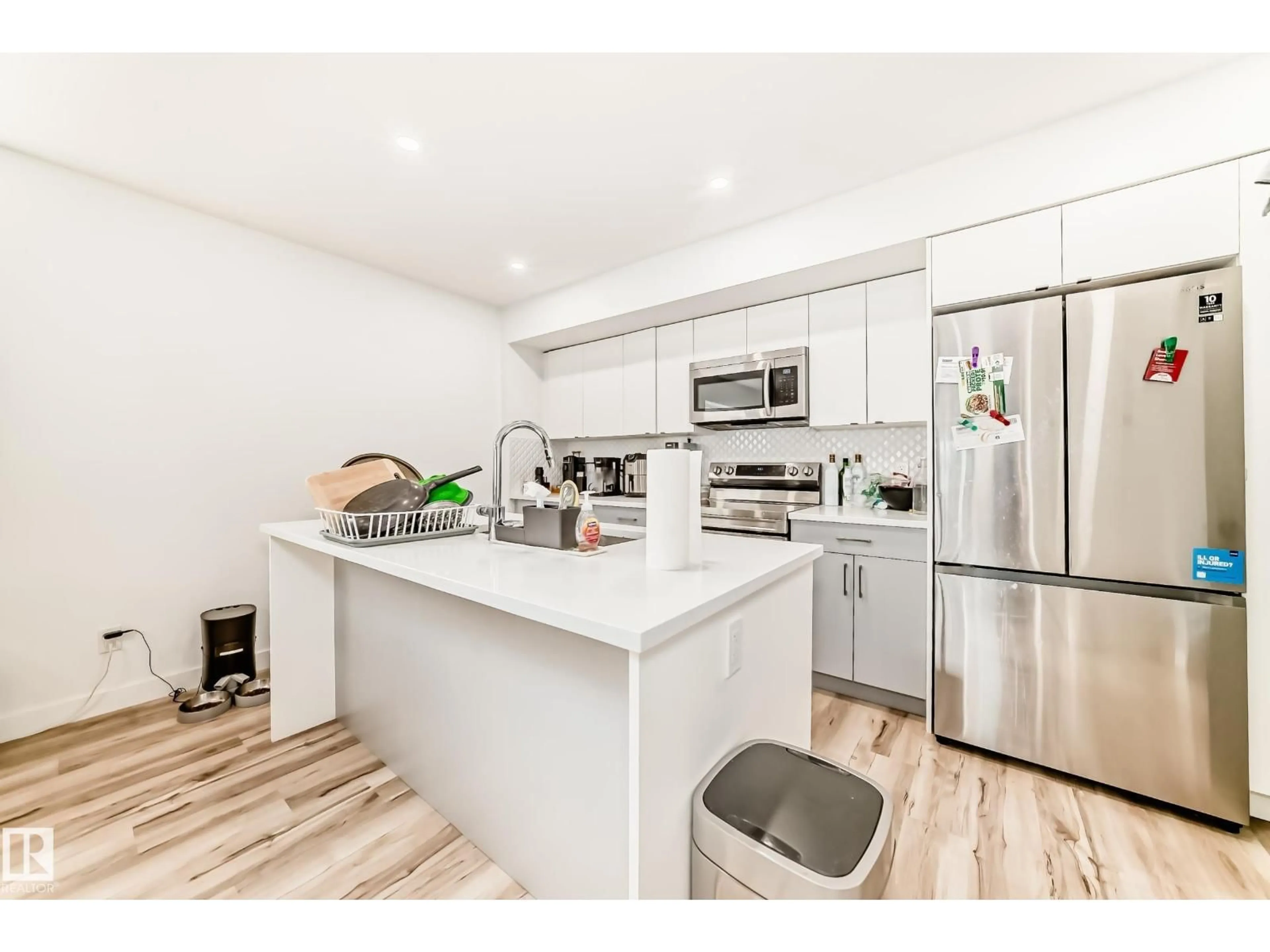 Open concept kitchen, wood/laminate floor for #2 - 11326 95A ST, Edmonton Alberta T5G1P1